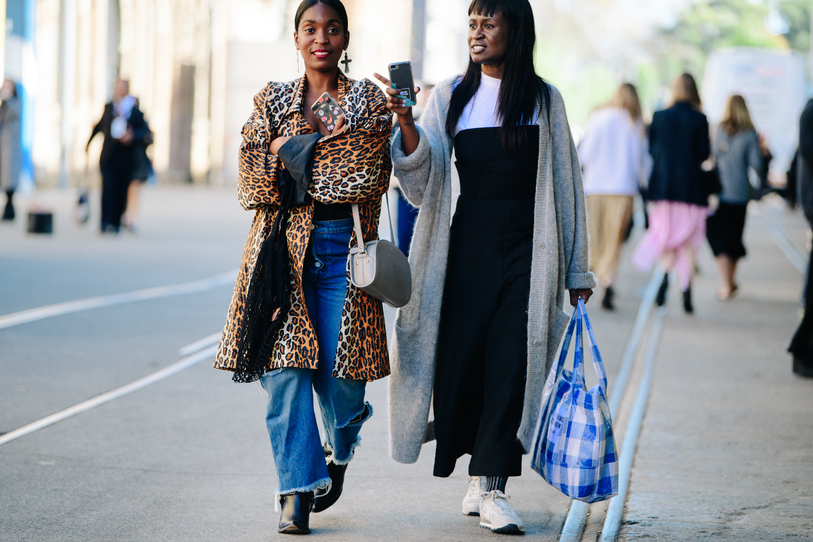 Two women wearing long coats