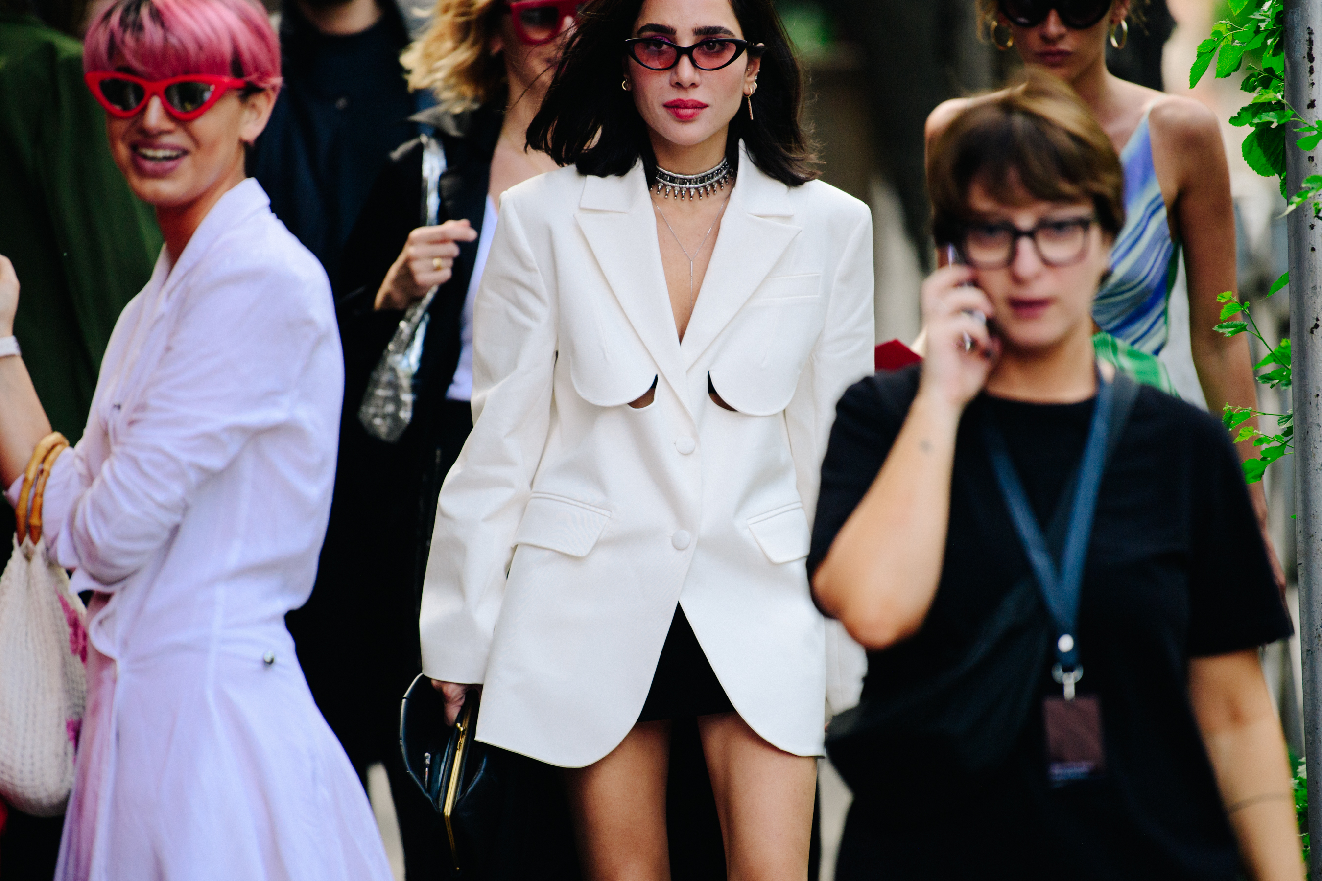 Woman wearing white jacket and sunglasses