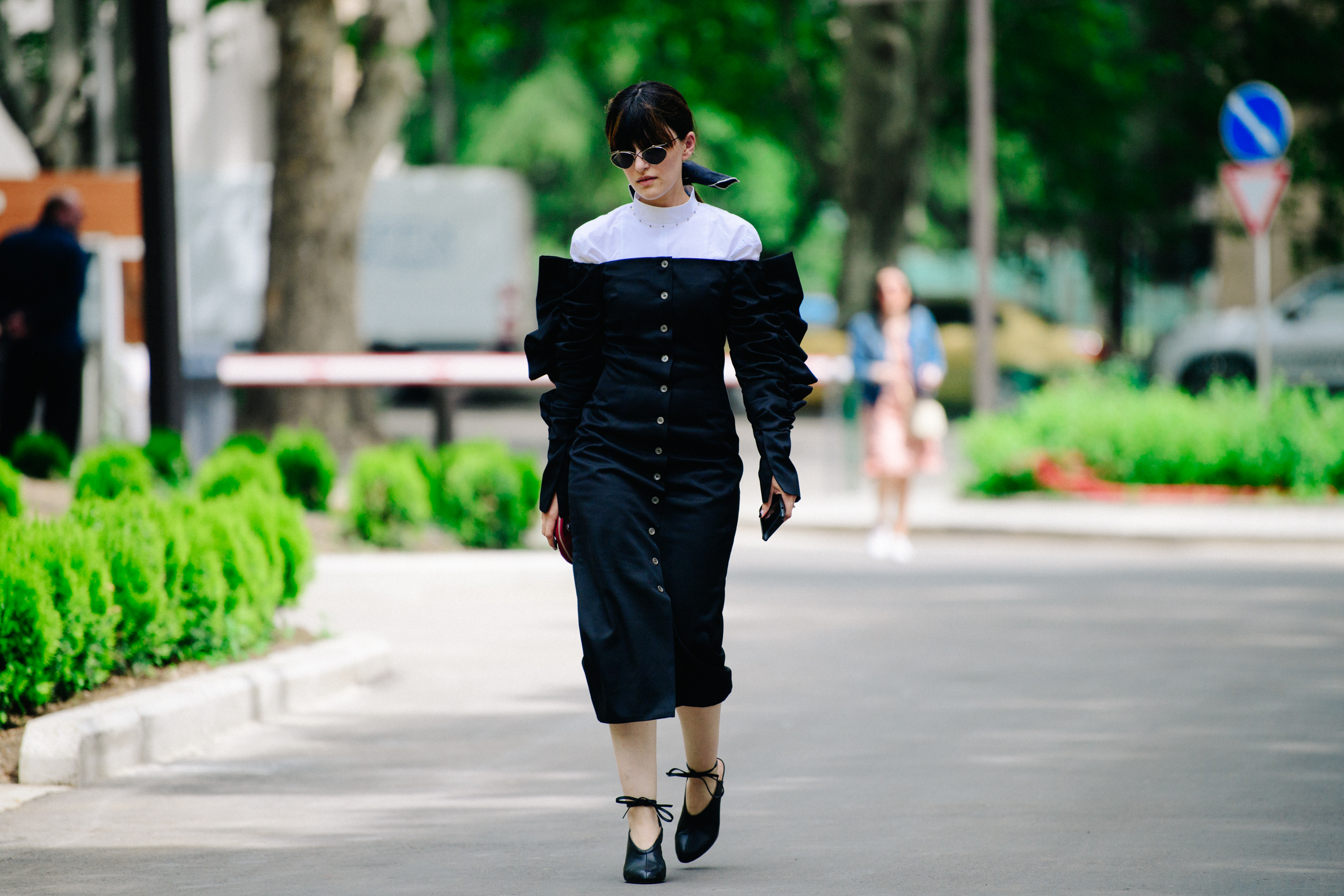 Woman wearing black button dress