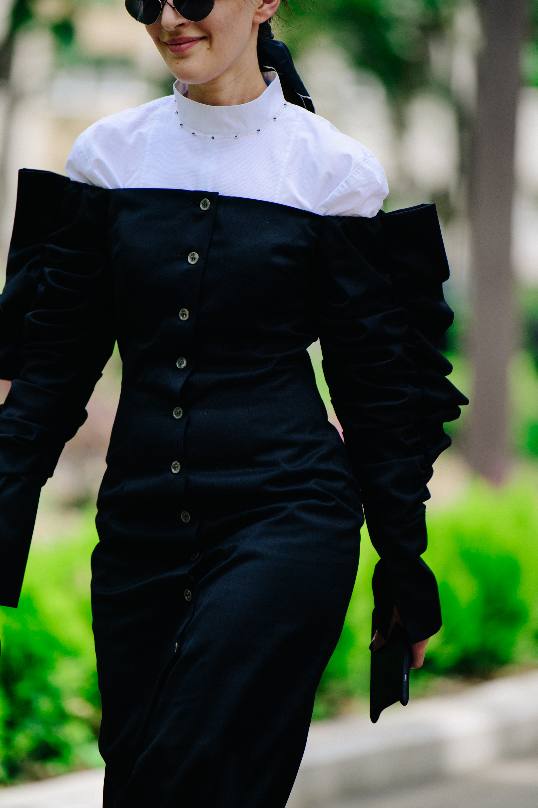 Woman wearing black button dress