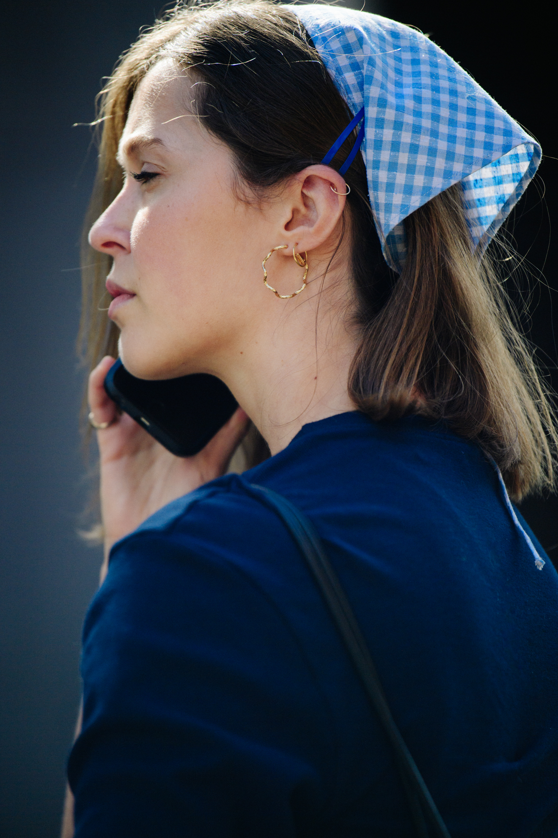 Woman wearing blue check scarf