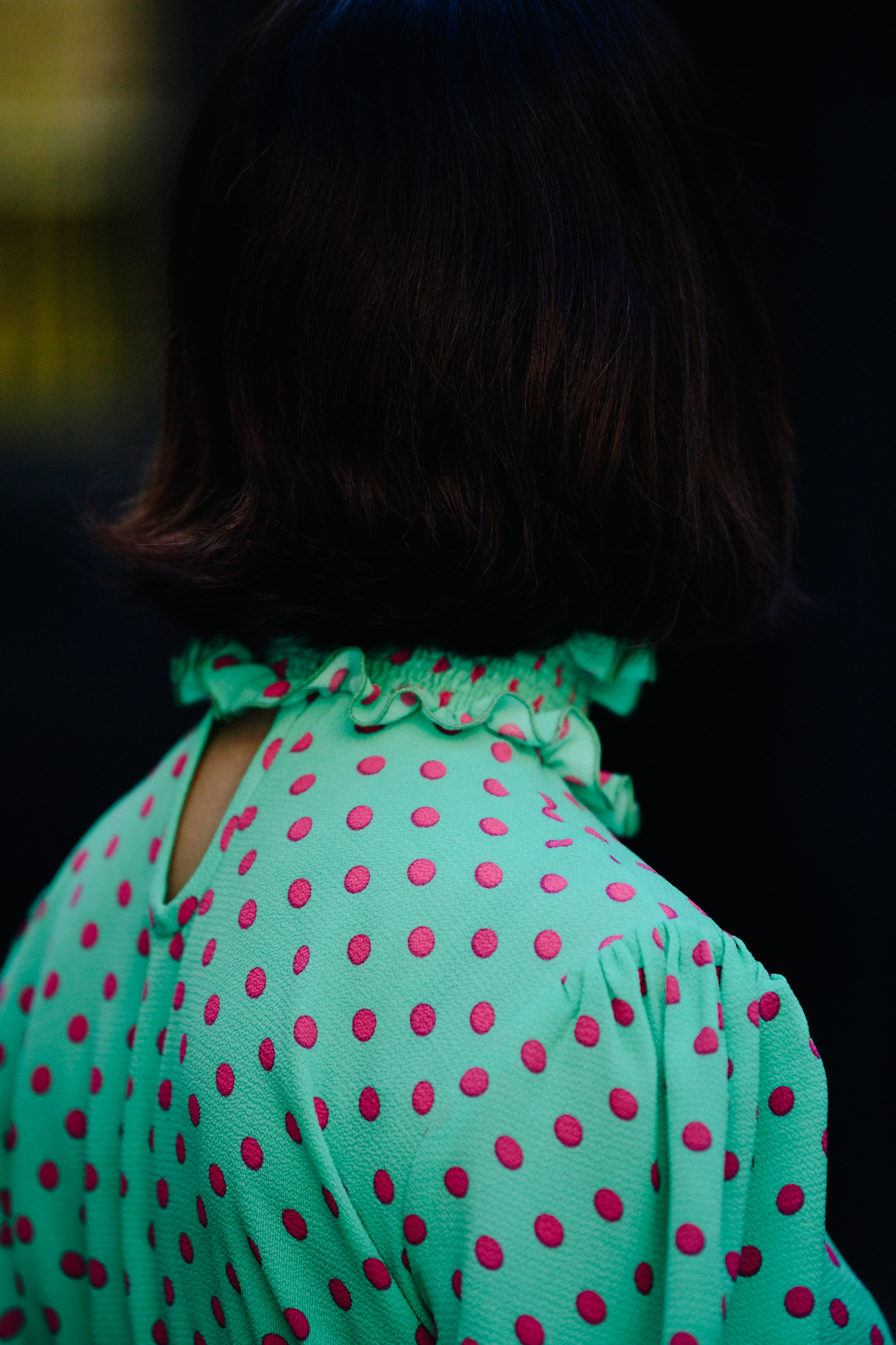 Woman wearing green spotted dress