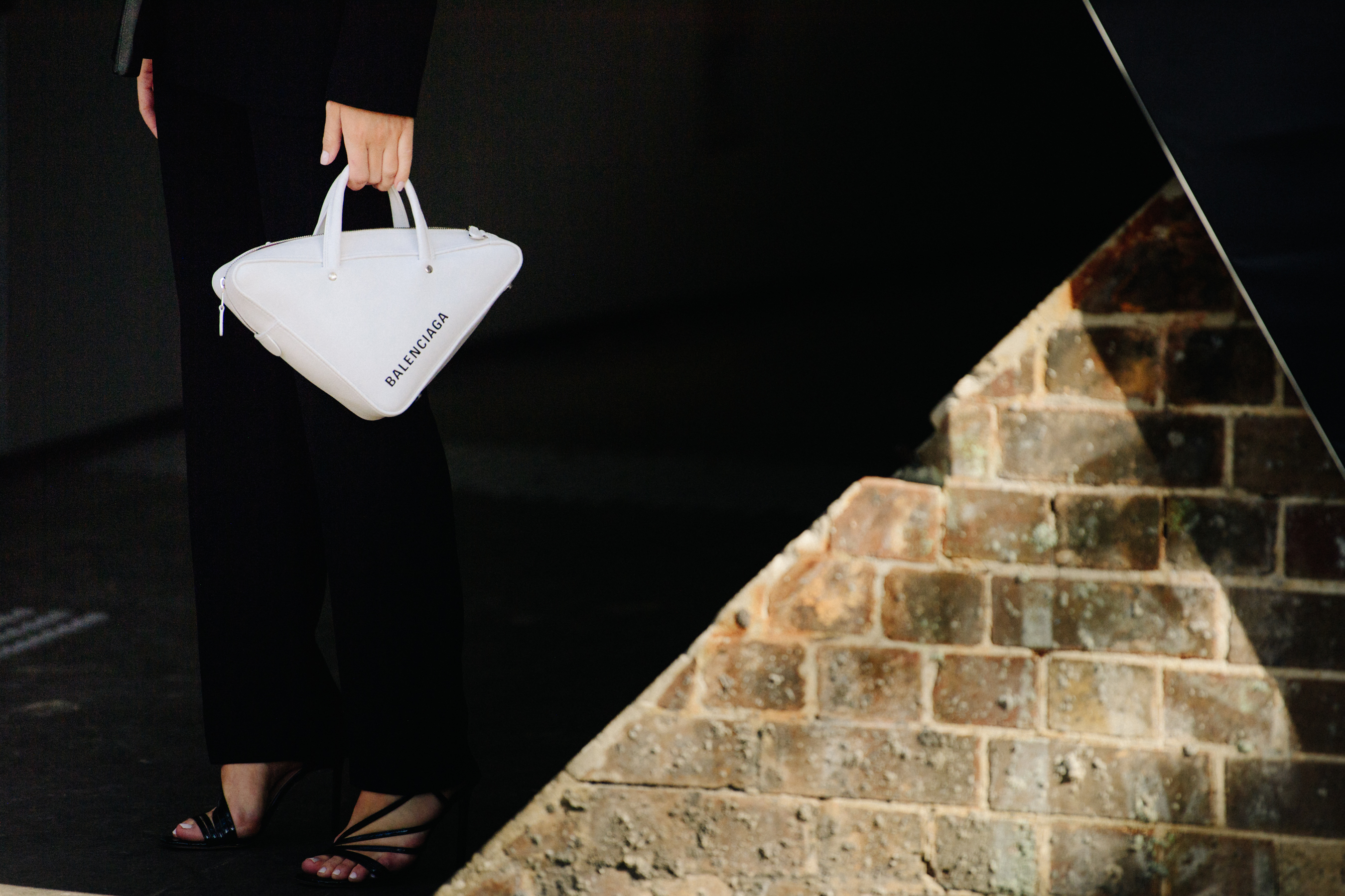 Woman carrying white leather bag