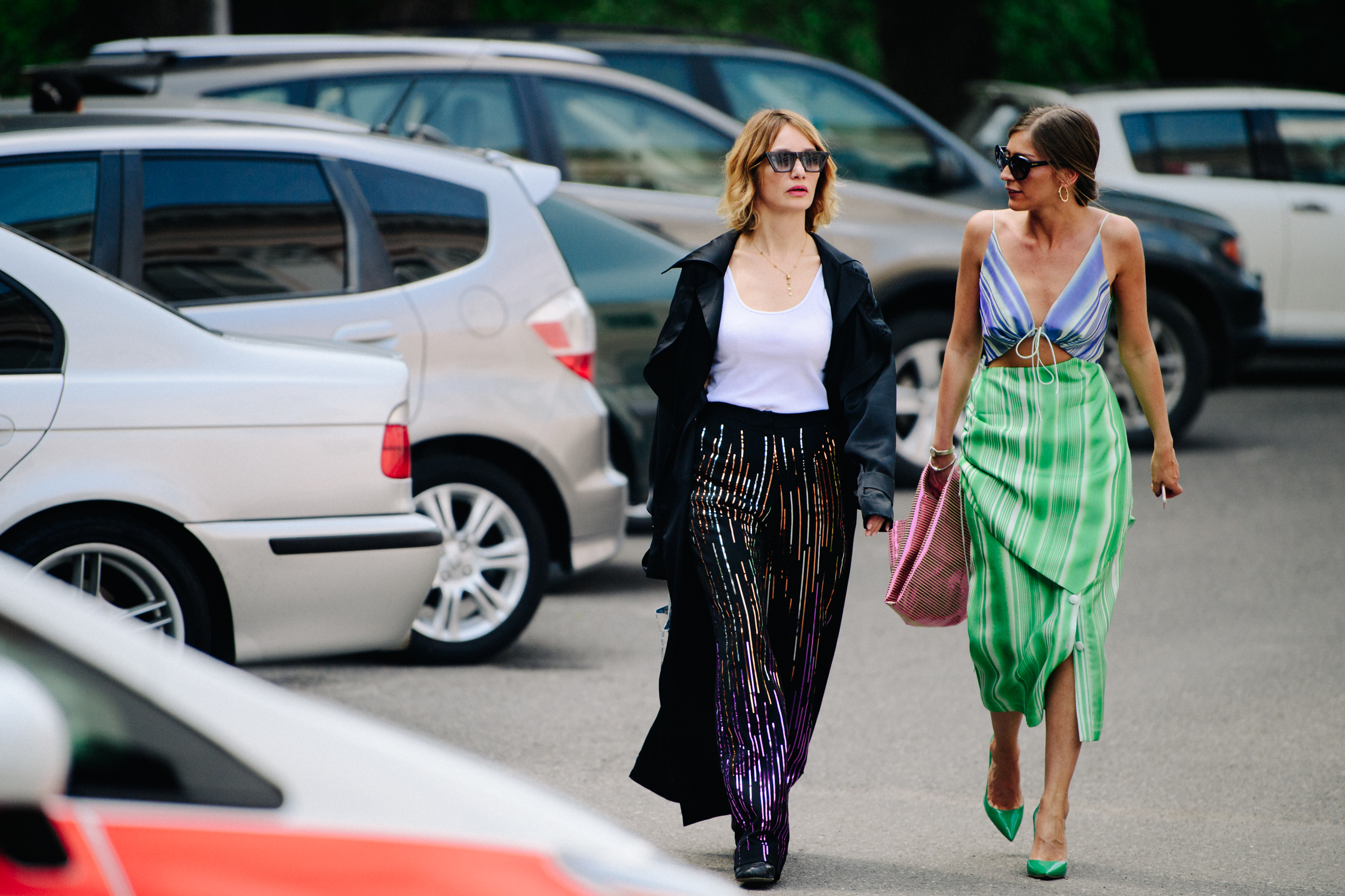 Two women wearing colourful clothing
