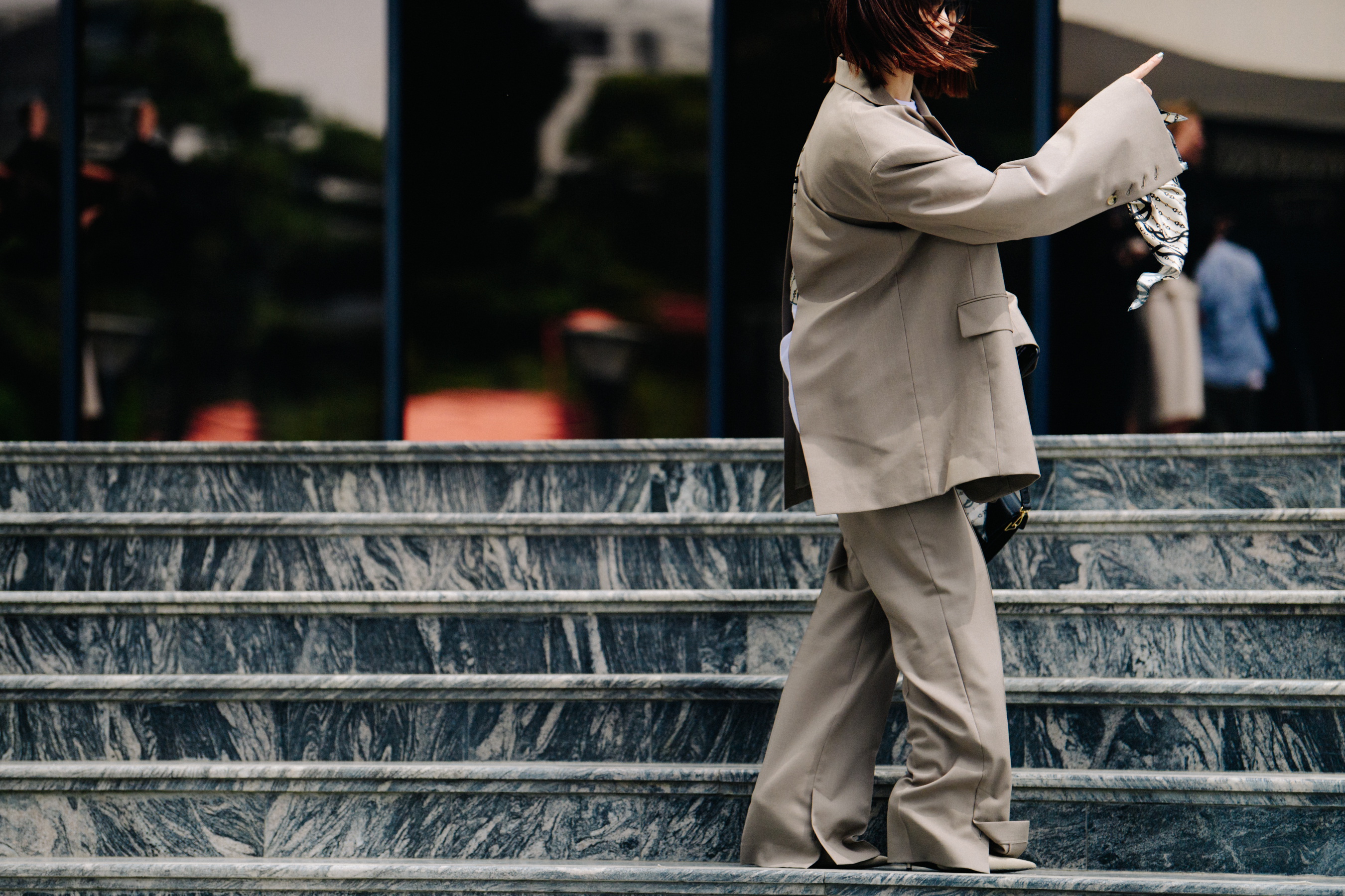 Asian woman wearing brown suit
