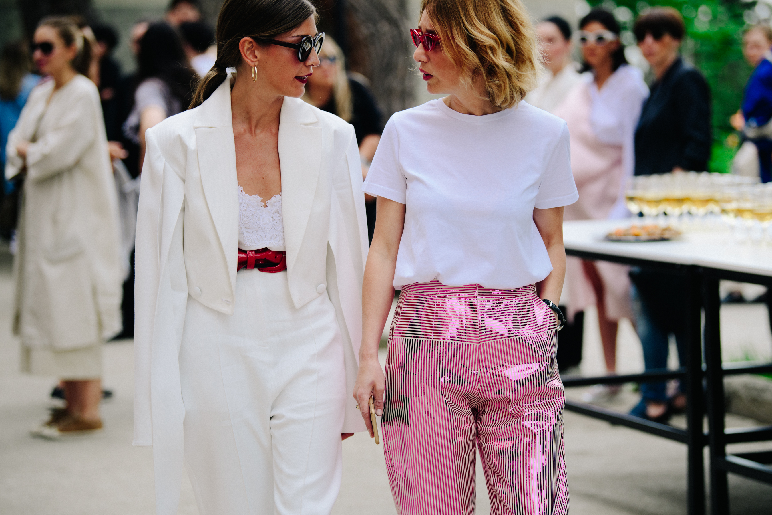 Two women wearing white summer outfits