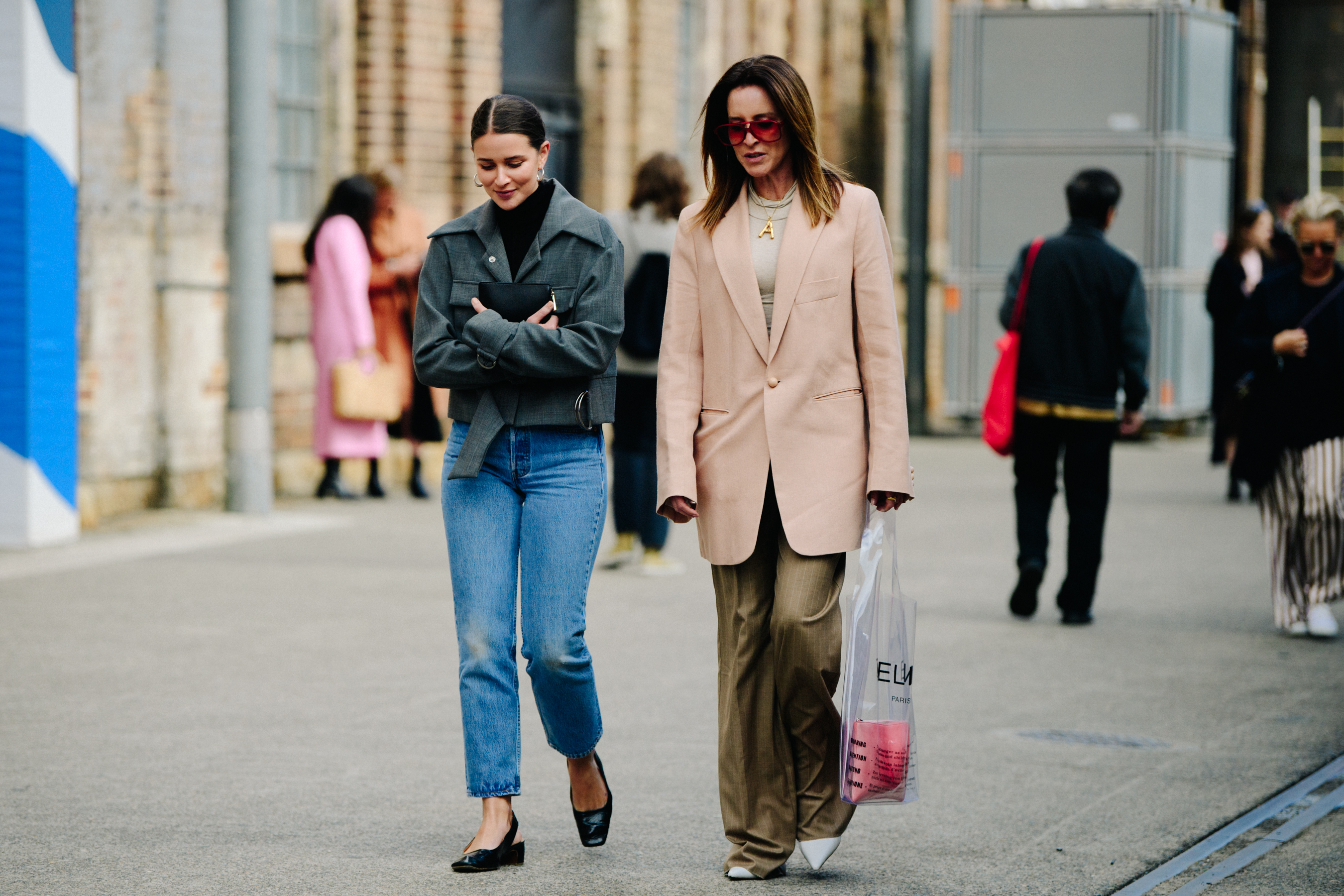 Two women wearing smart jackets