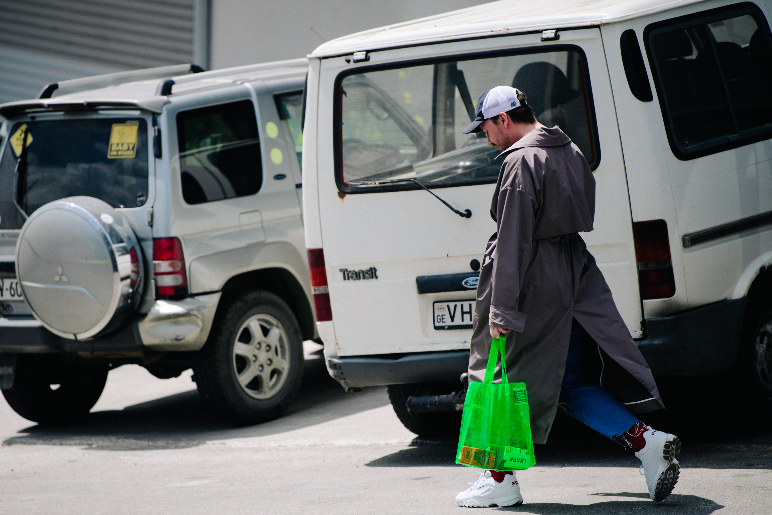 Man carrying green plastic bag