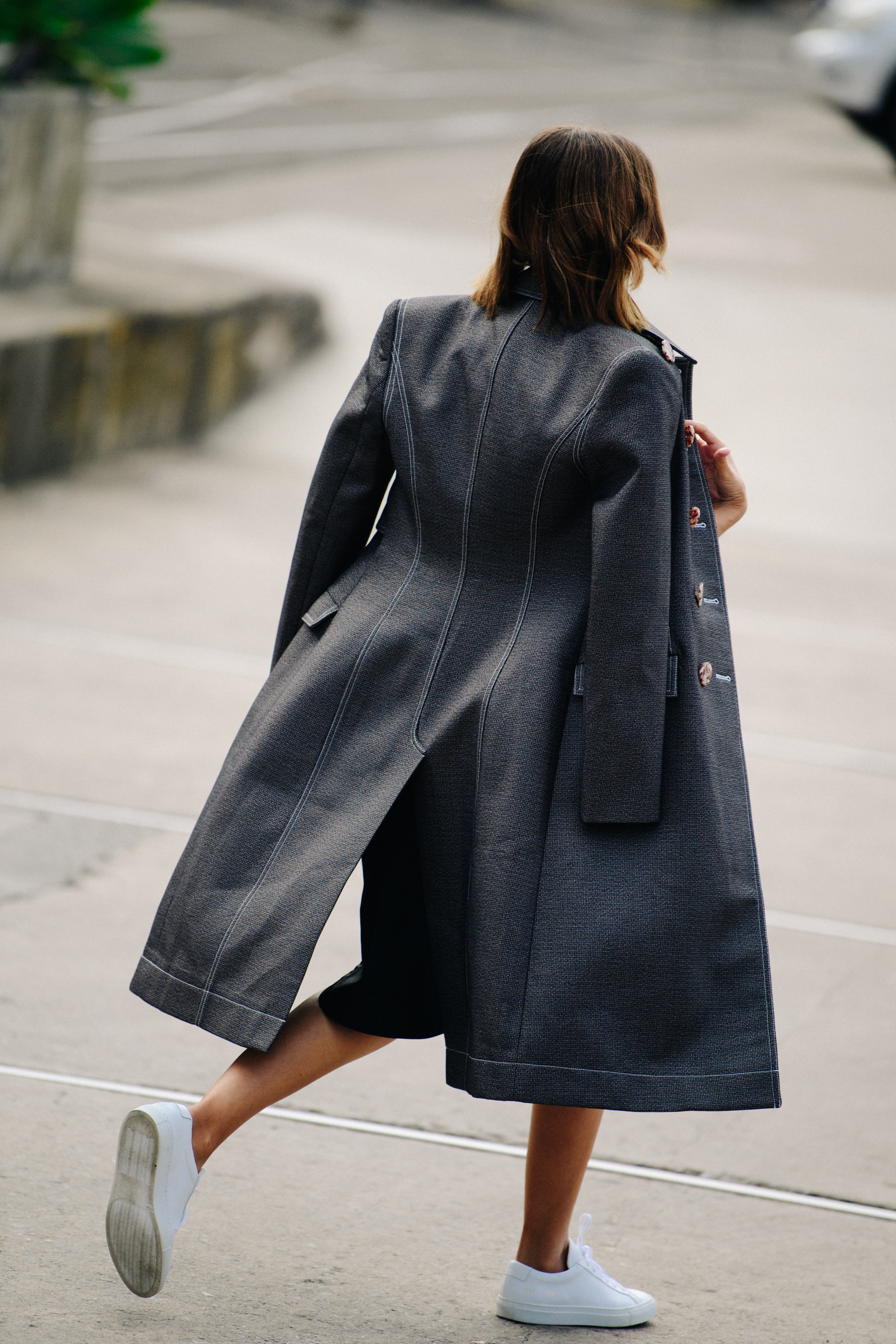 Woman wearing long grey coat