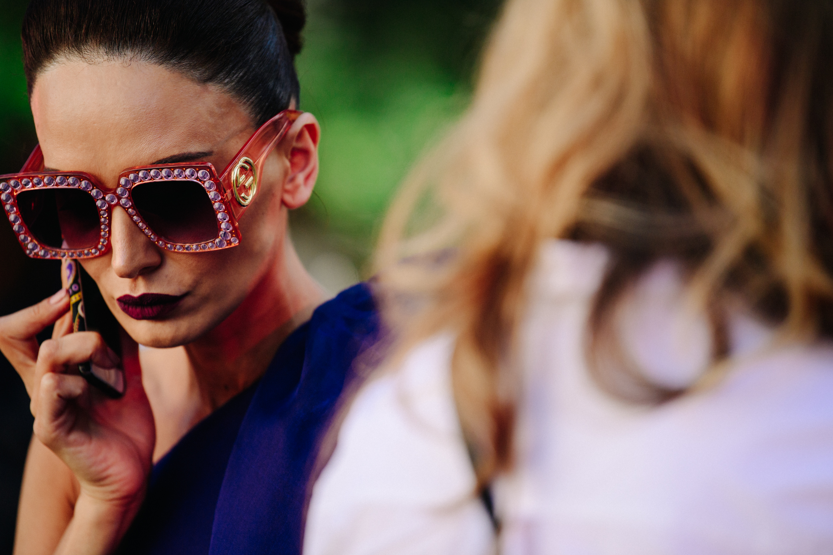 Woman wearing red plastic sunglasses