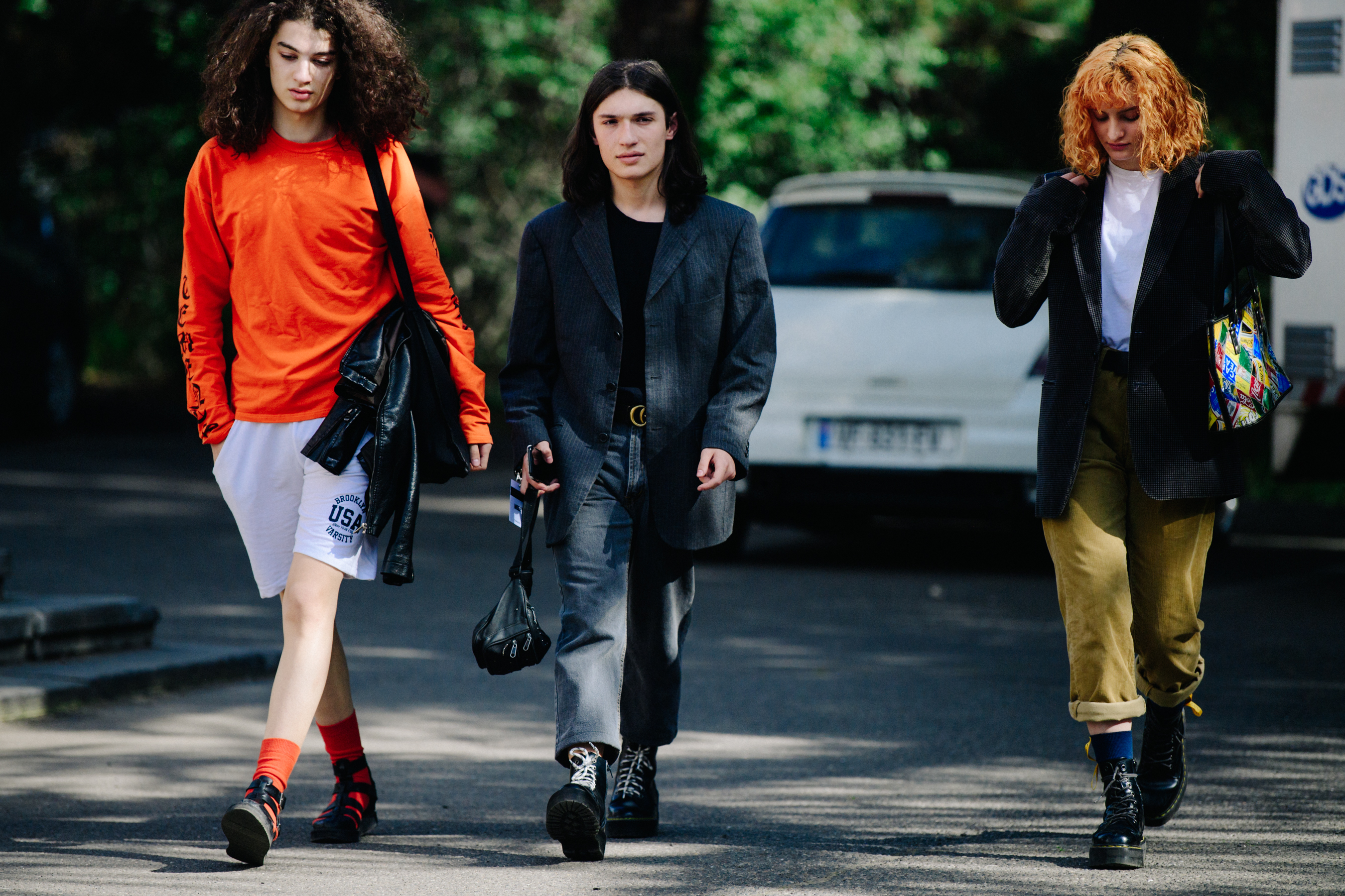 Three models wearing dark outfits