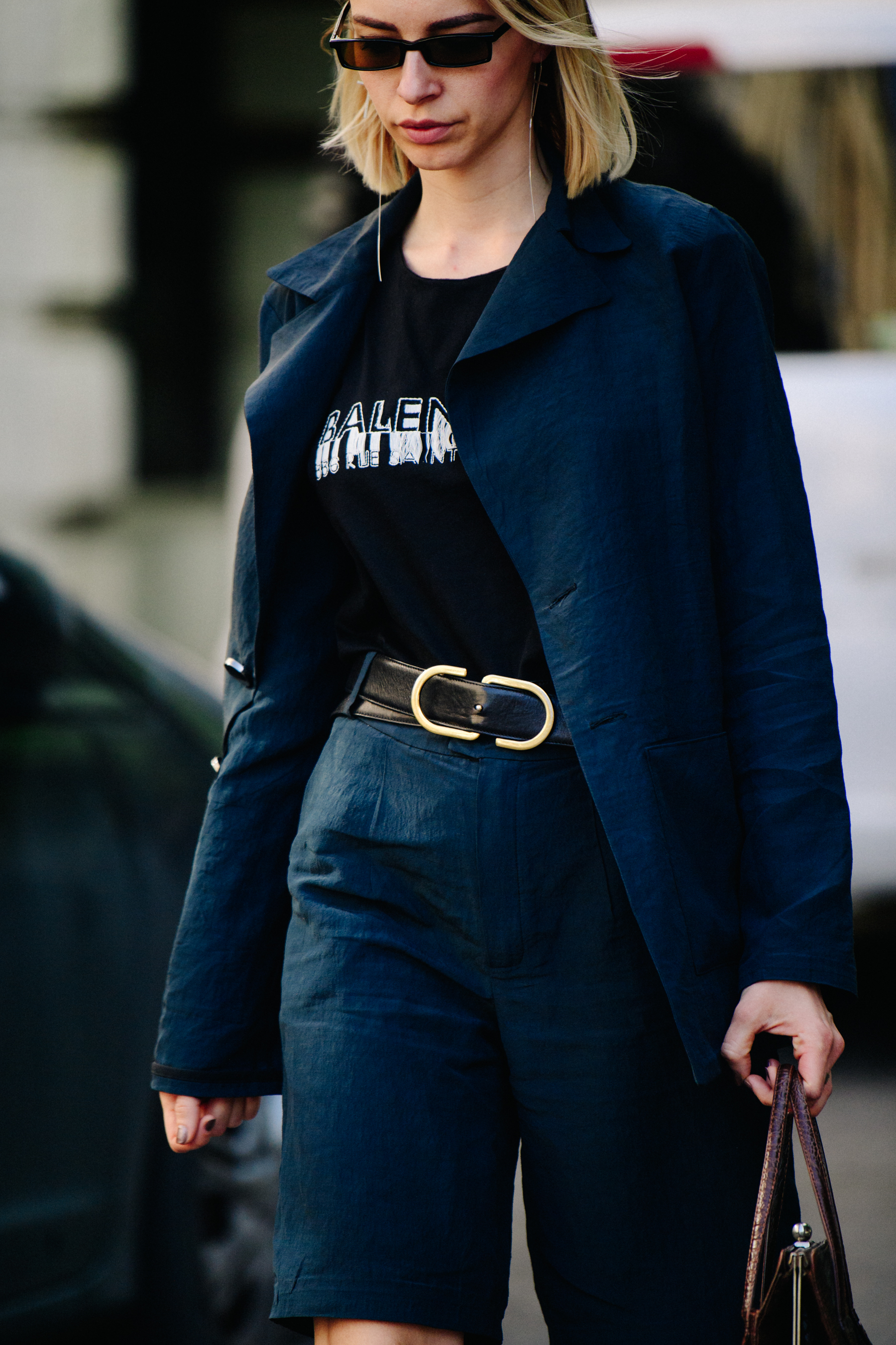 Woman wearing blue jacket and shorts