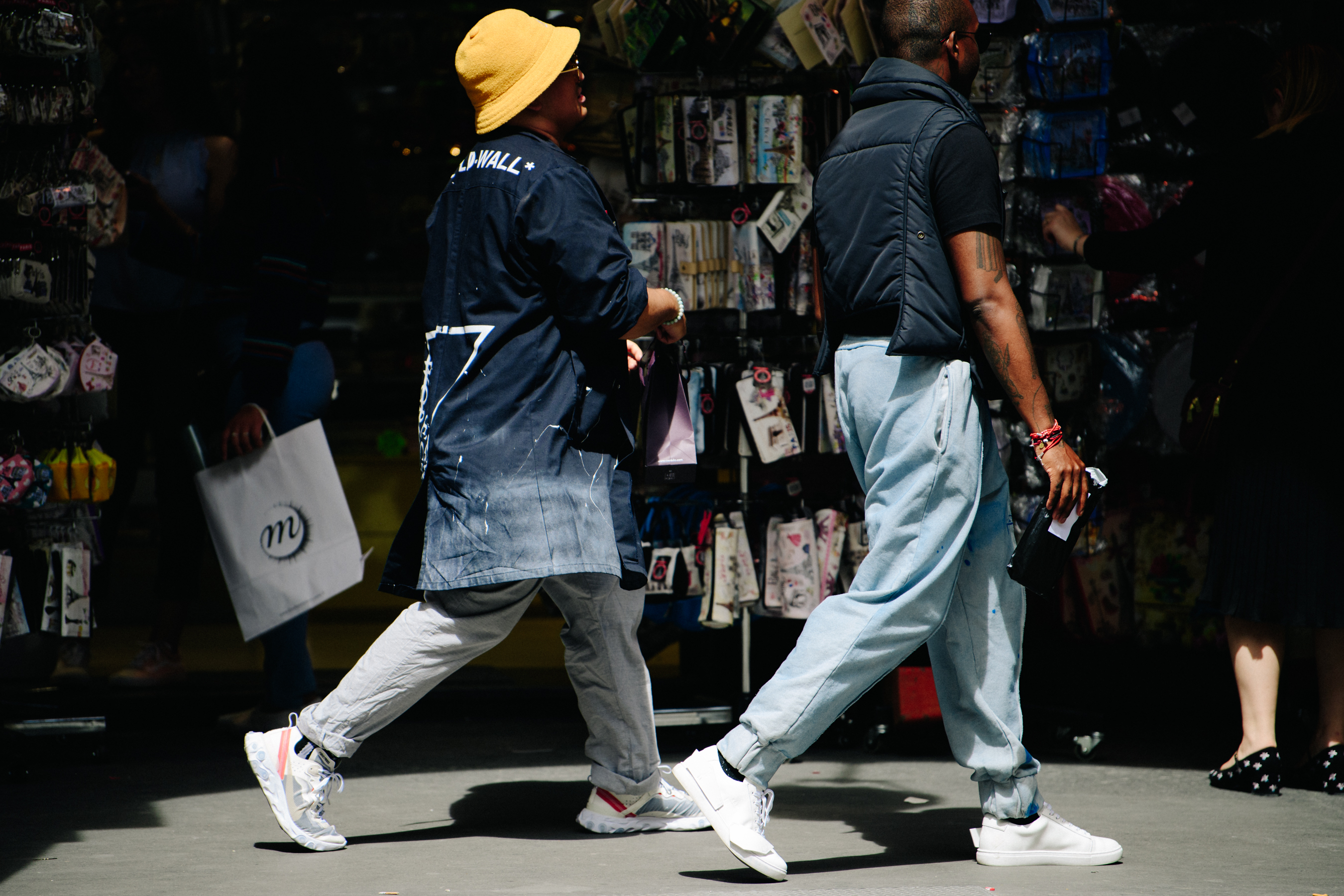 Two men wearing white sneakers