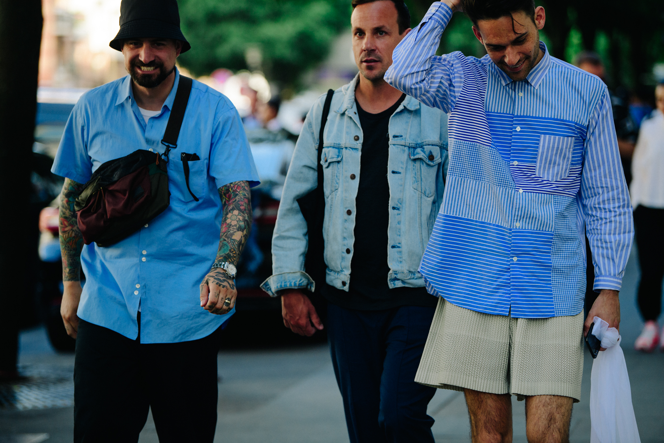 Three men wearing blue