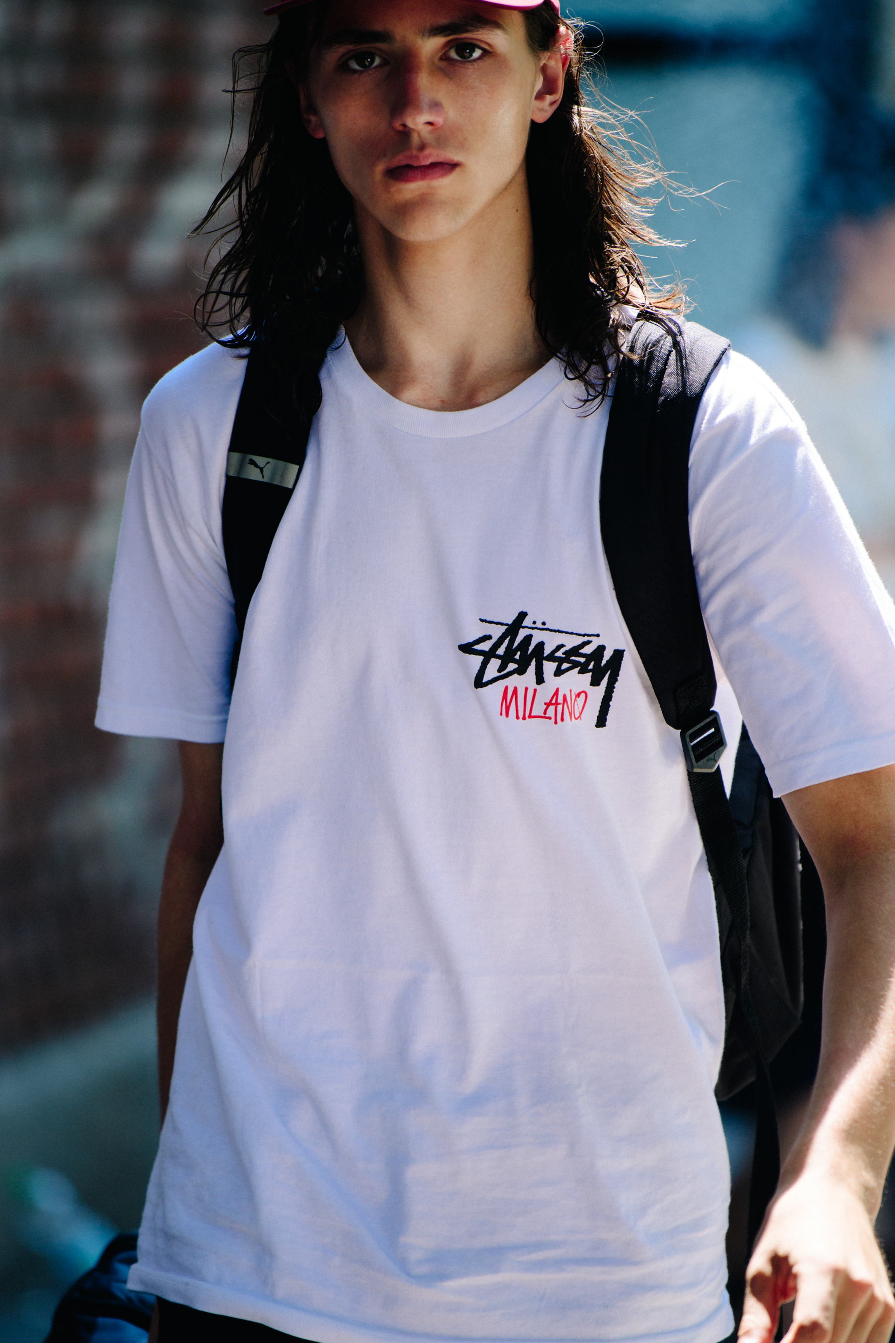 Model wearing white Stussy shirt