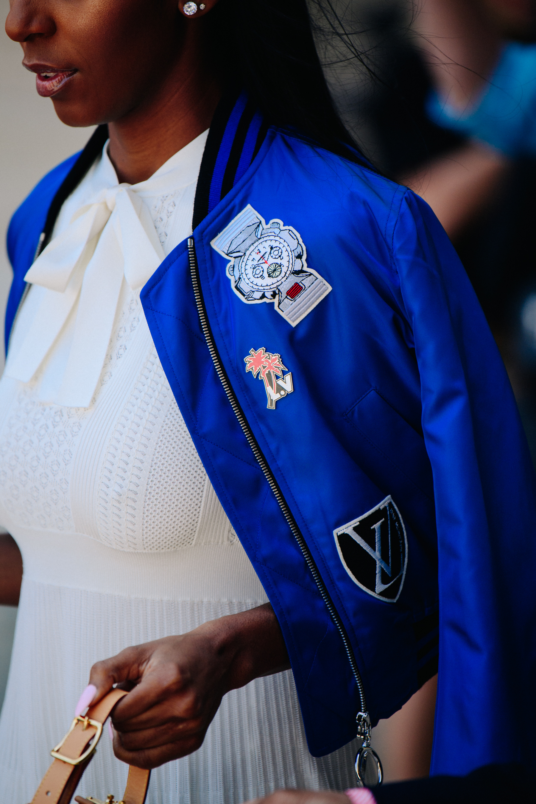 Woman wearing blue Louis Vuitton coat
