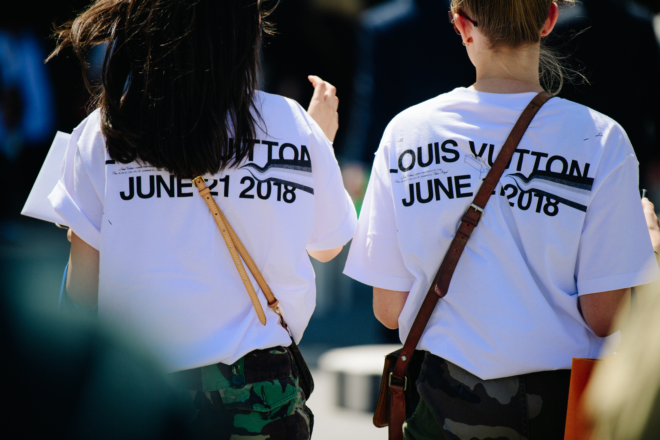 Two women wearing Louis Vuitton tee shirts