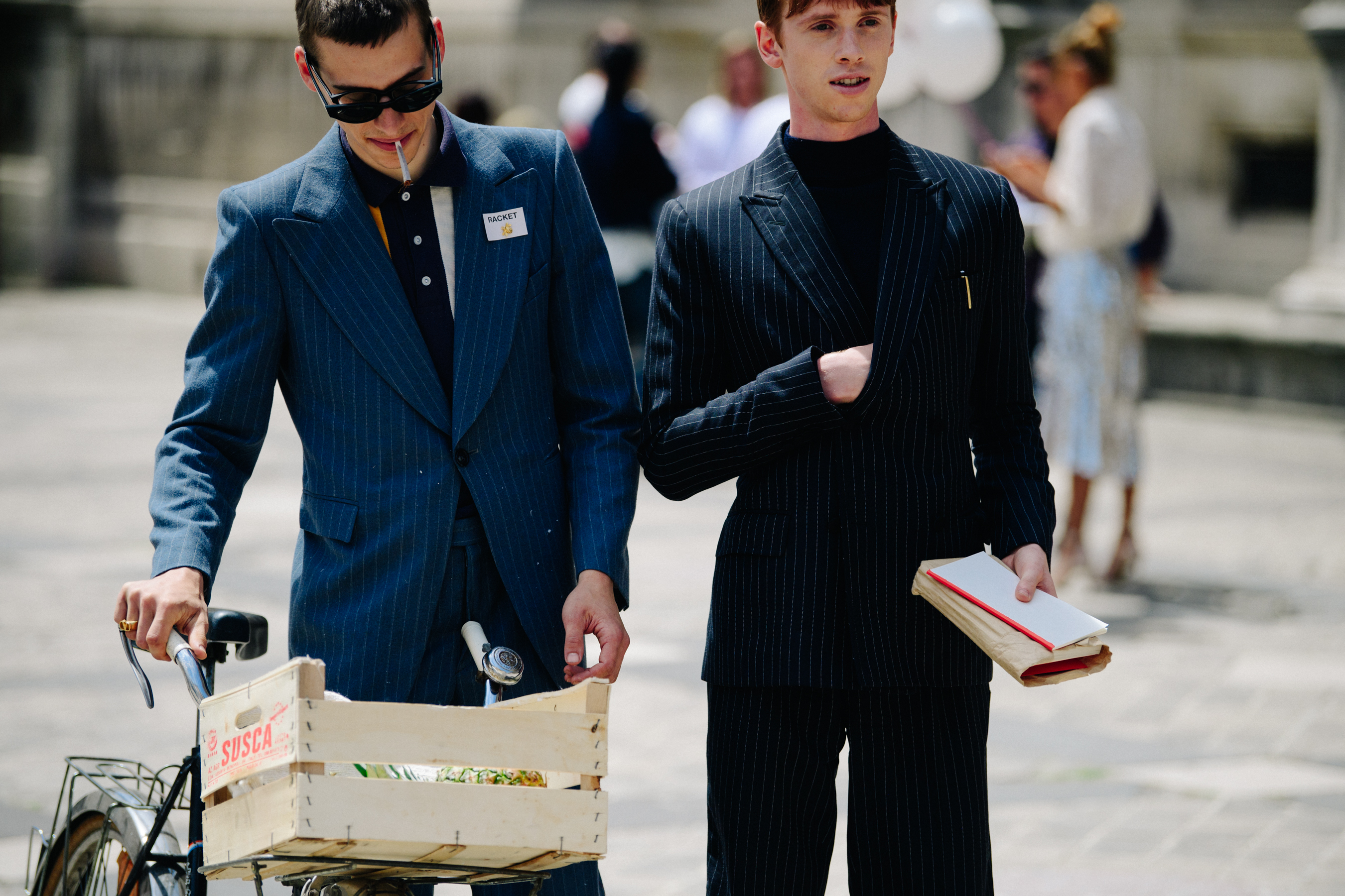 Two models wearing striped jackets