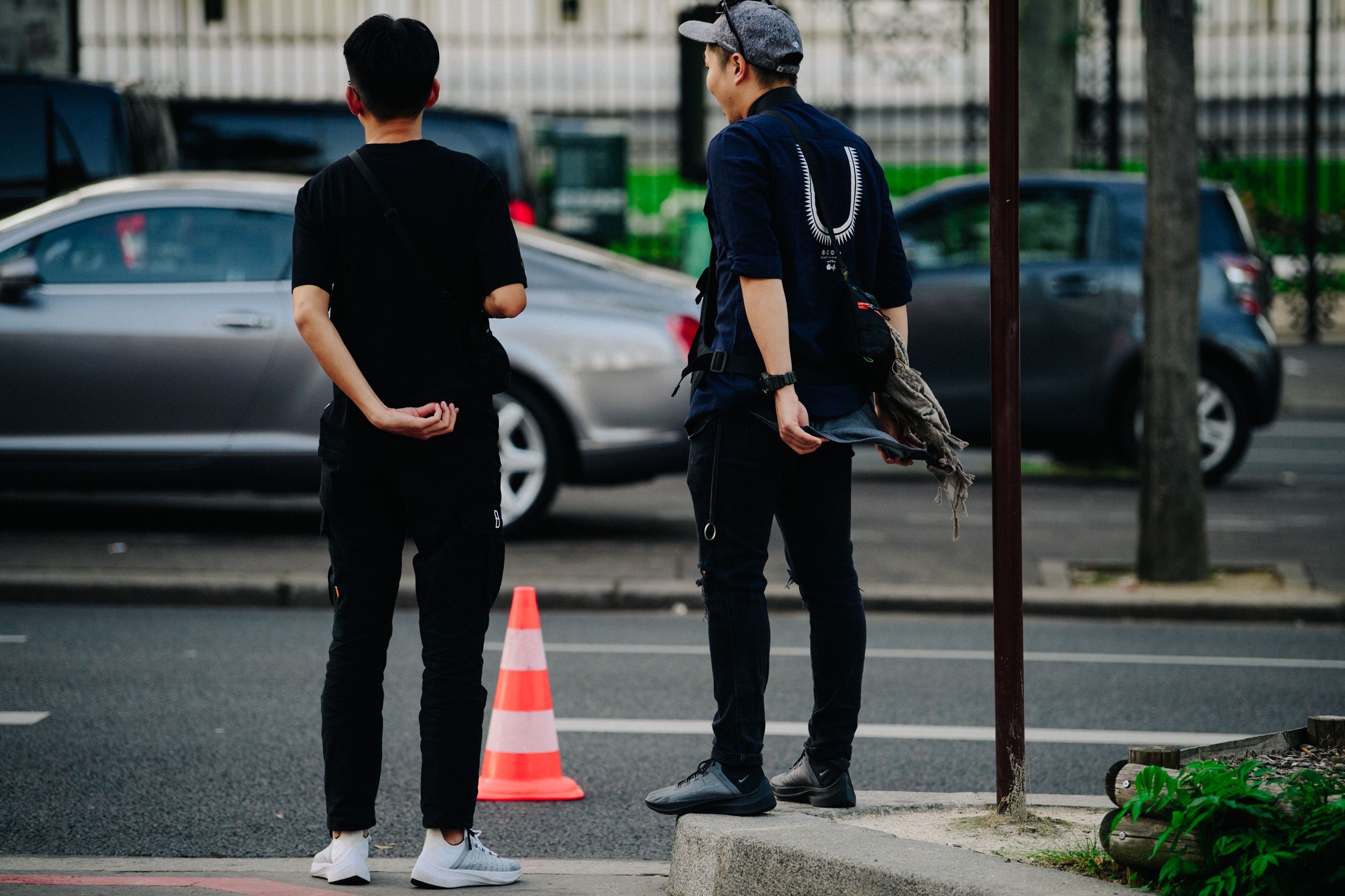 Two men wearing dark outfits