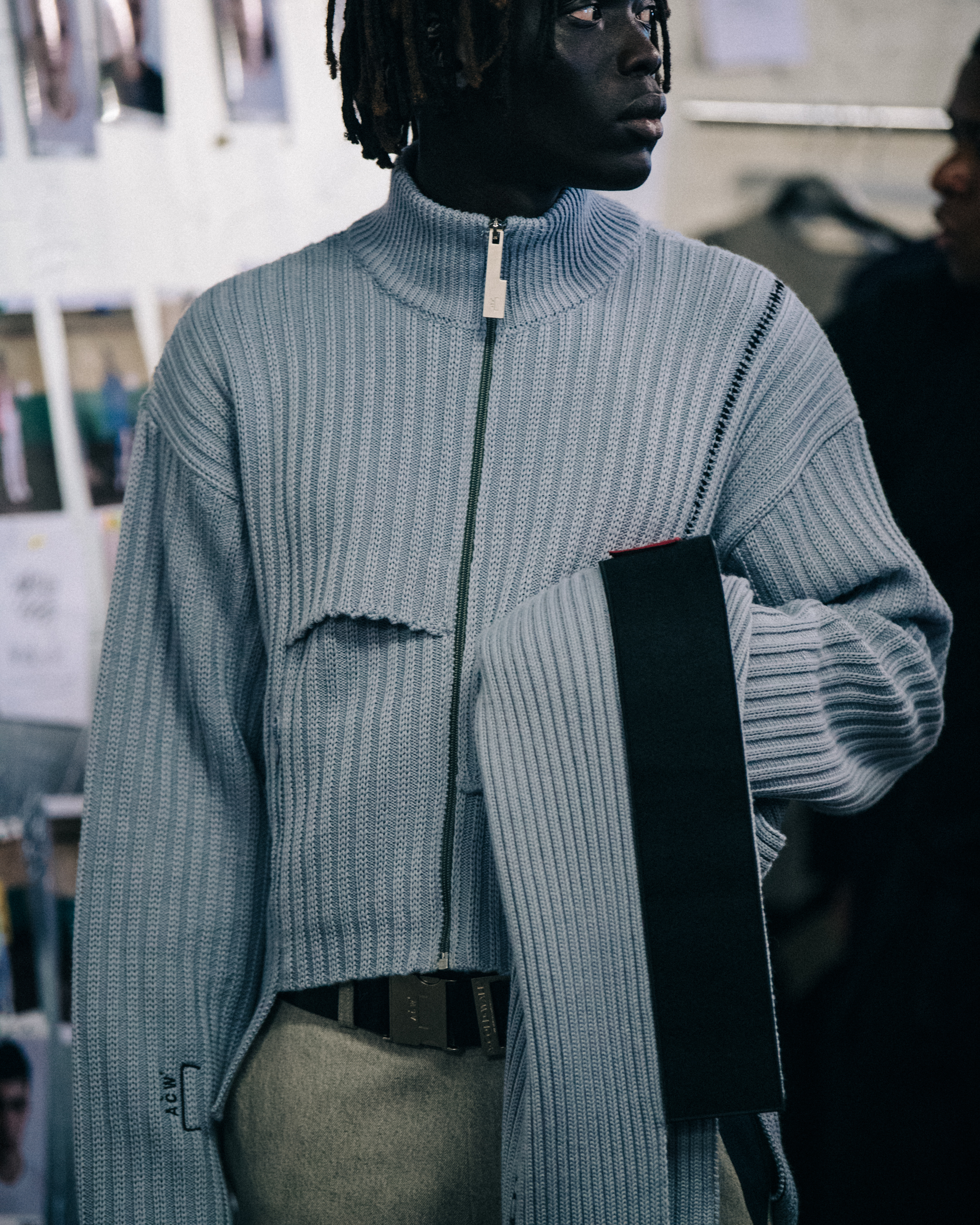 Model wearing grey zip top