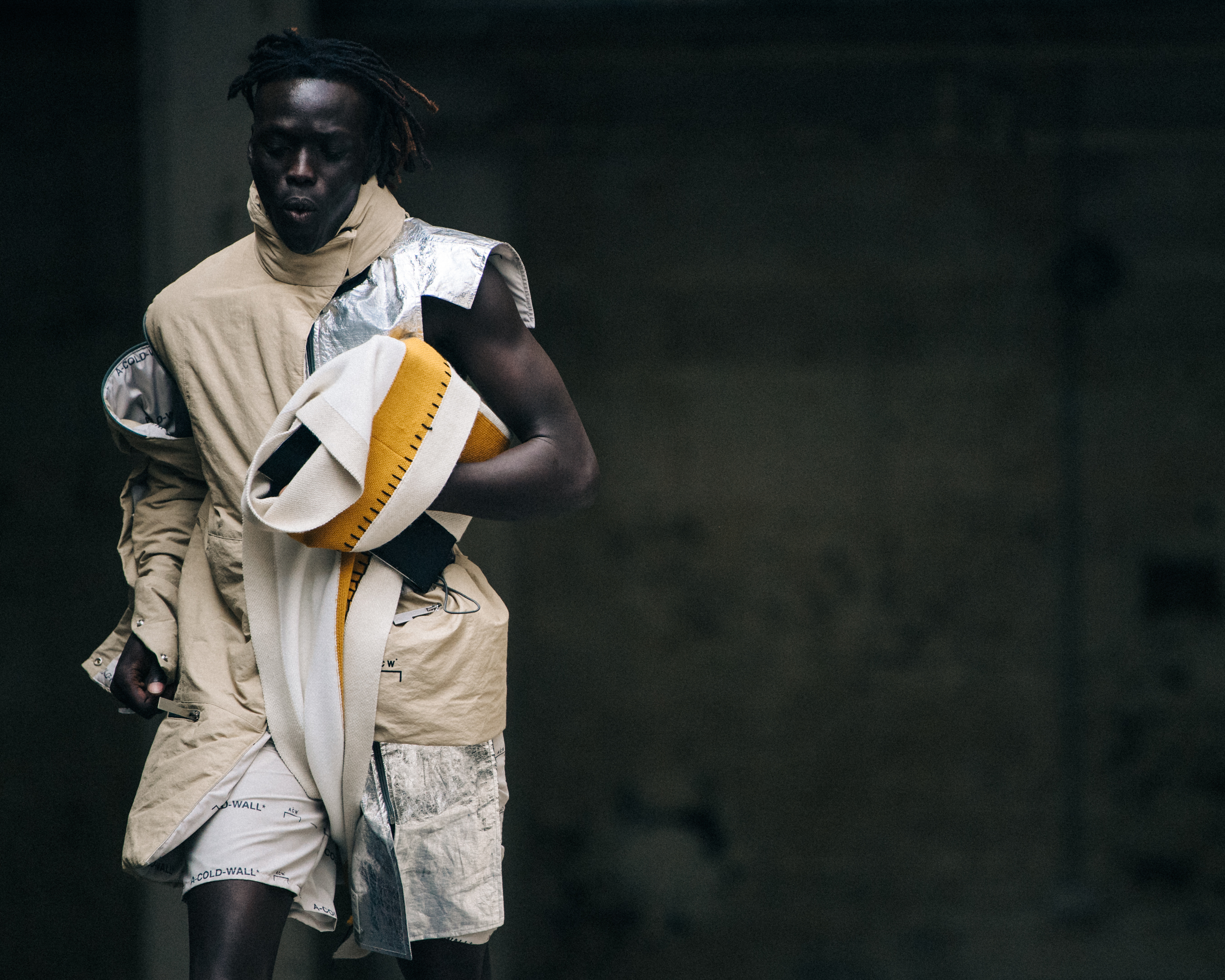 Model carrying coat at A-Cold-Wall*