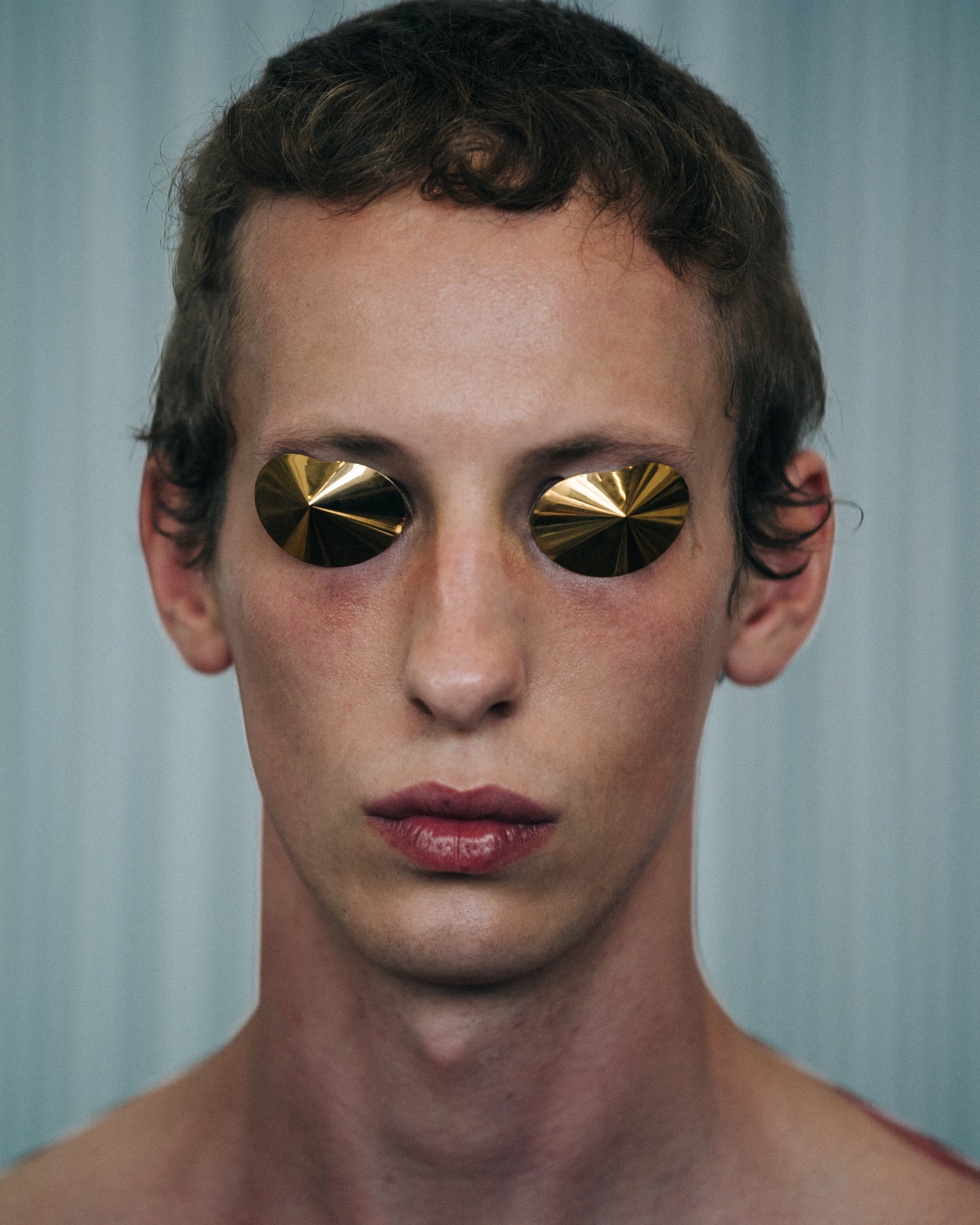 Portrait of model with gold eye covers