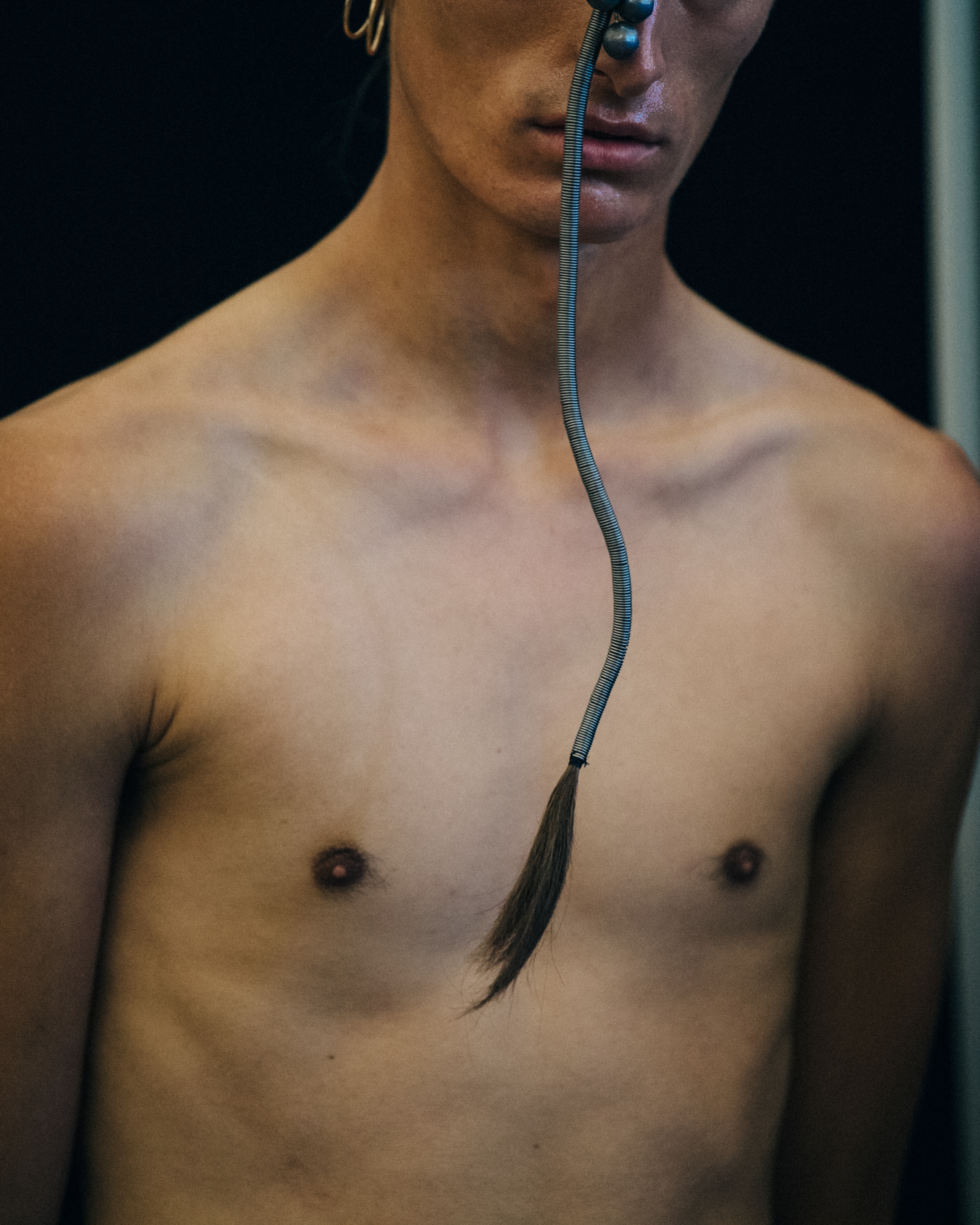 Model with long braided hair backstage