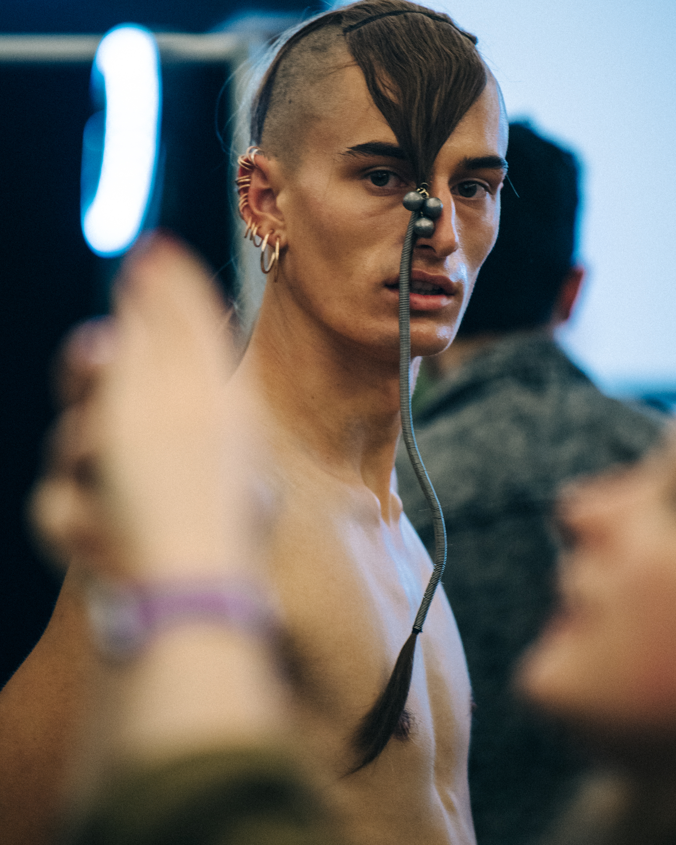 Model with long braided hair backstage