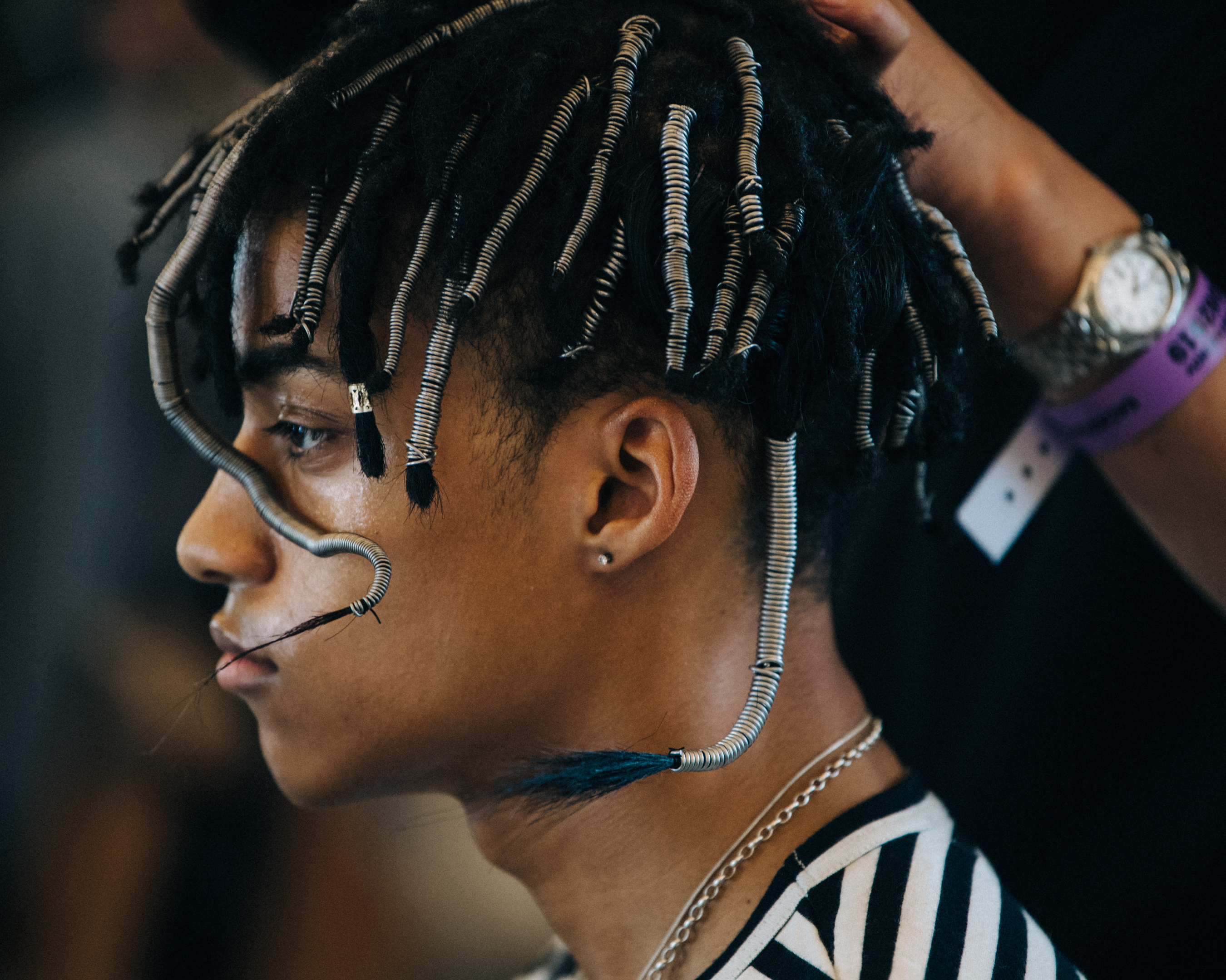 Model with long braided hair backstage