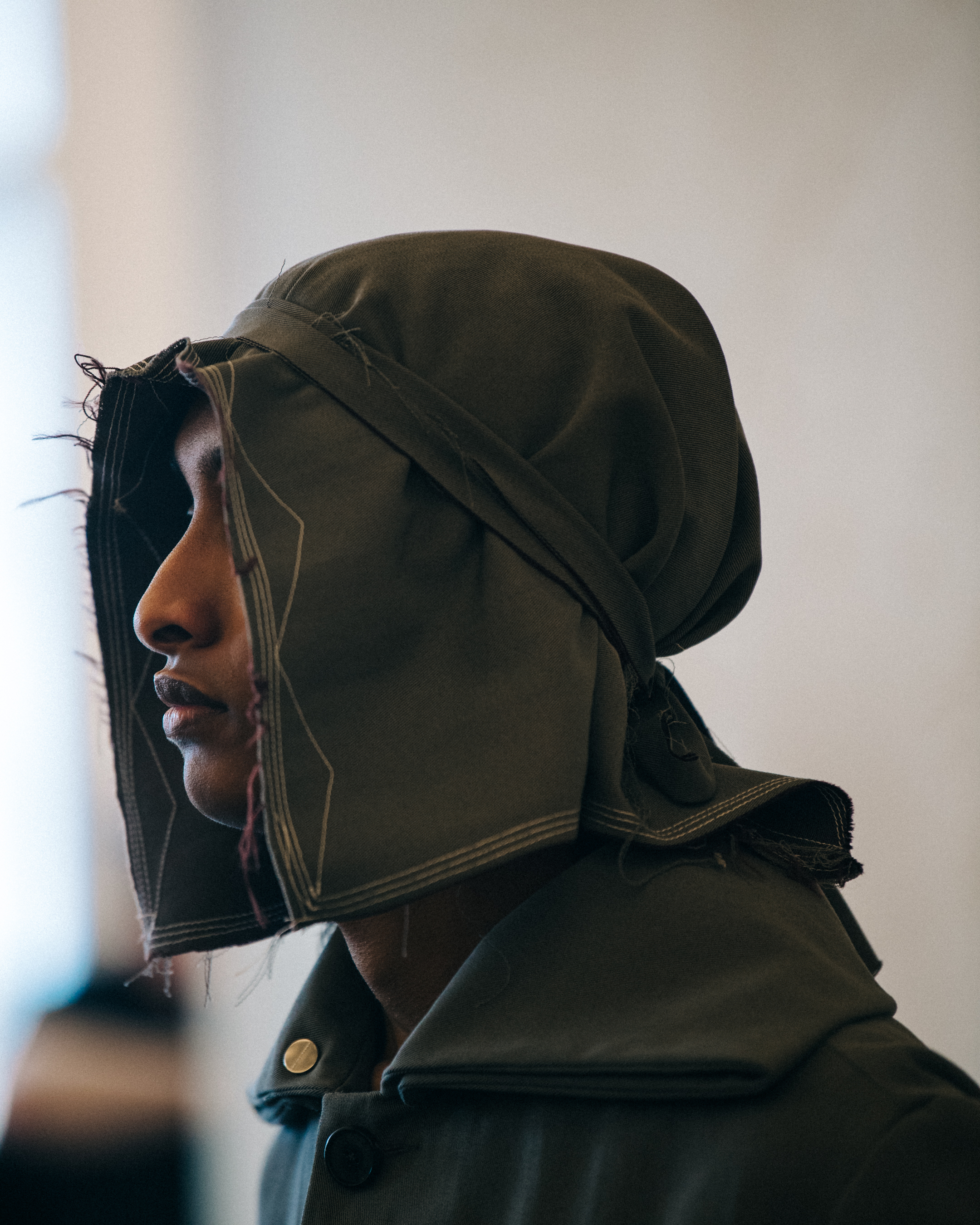 Models wearing hoods backstage