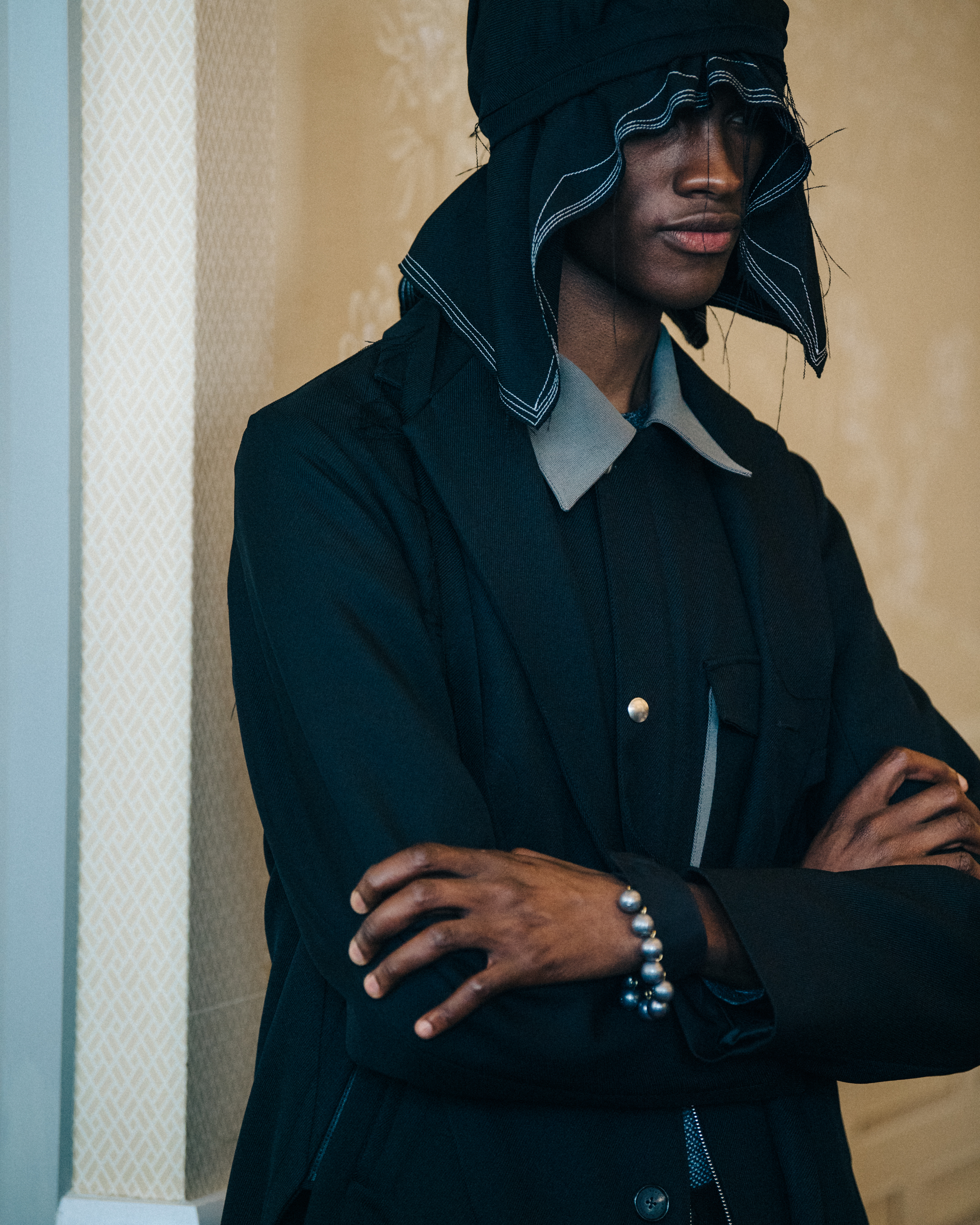 Models wearing hoods backstage