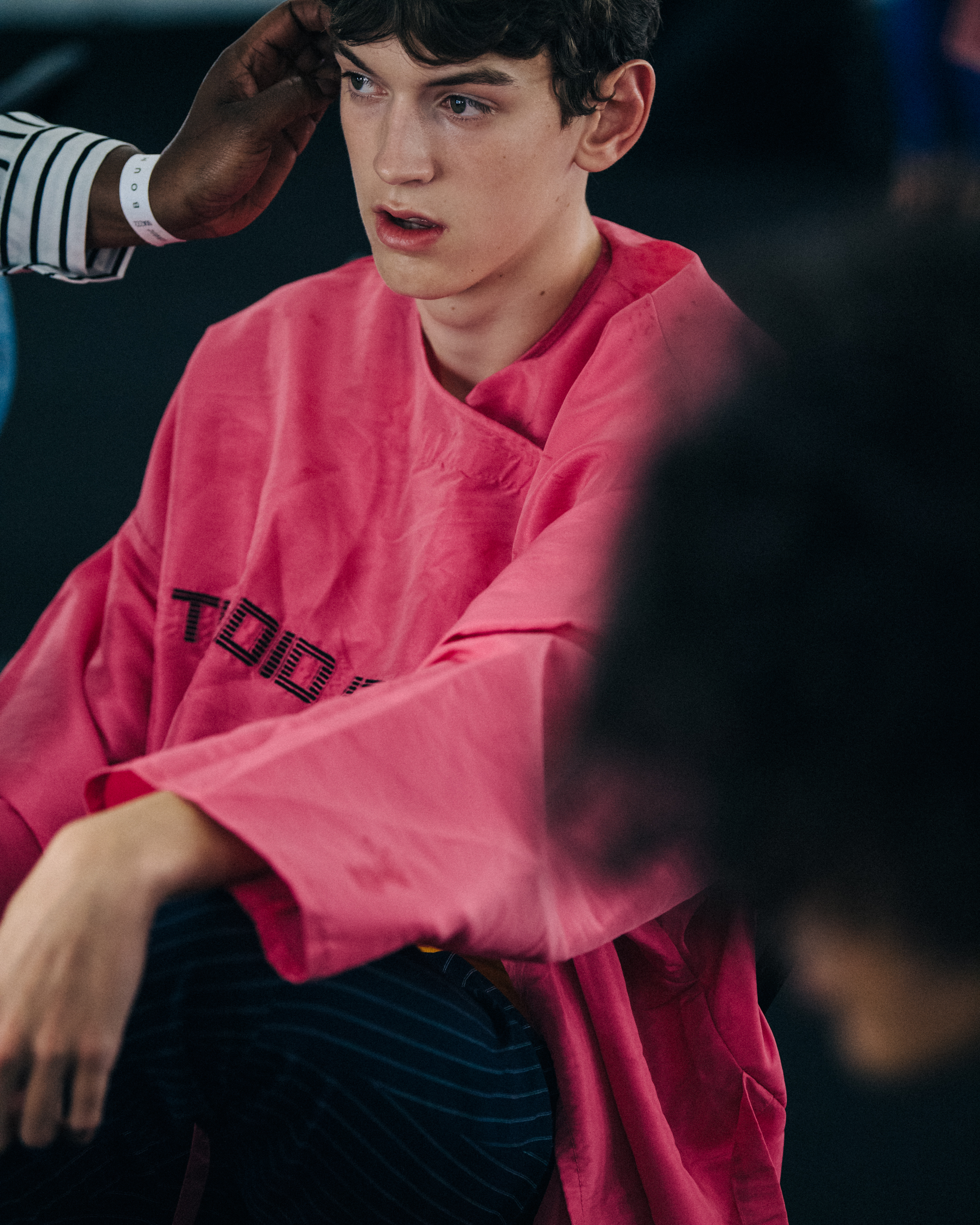Model wearing pink backstage at Qasimi