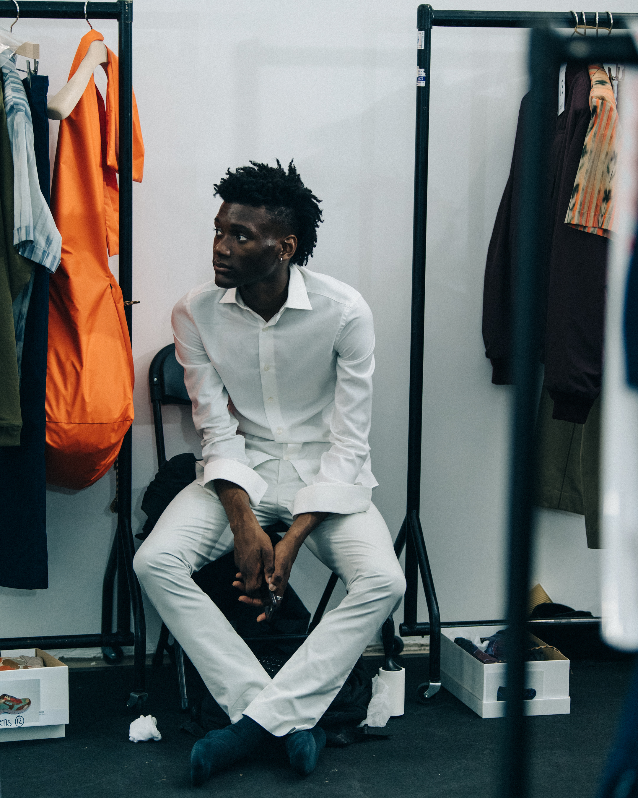 Model wearing white outfit backstage