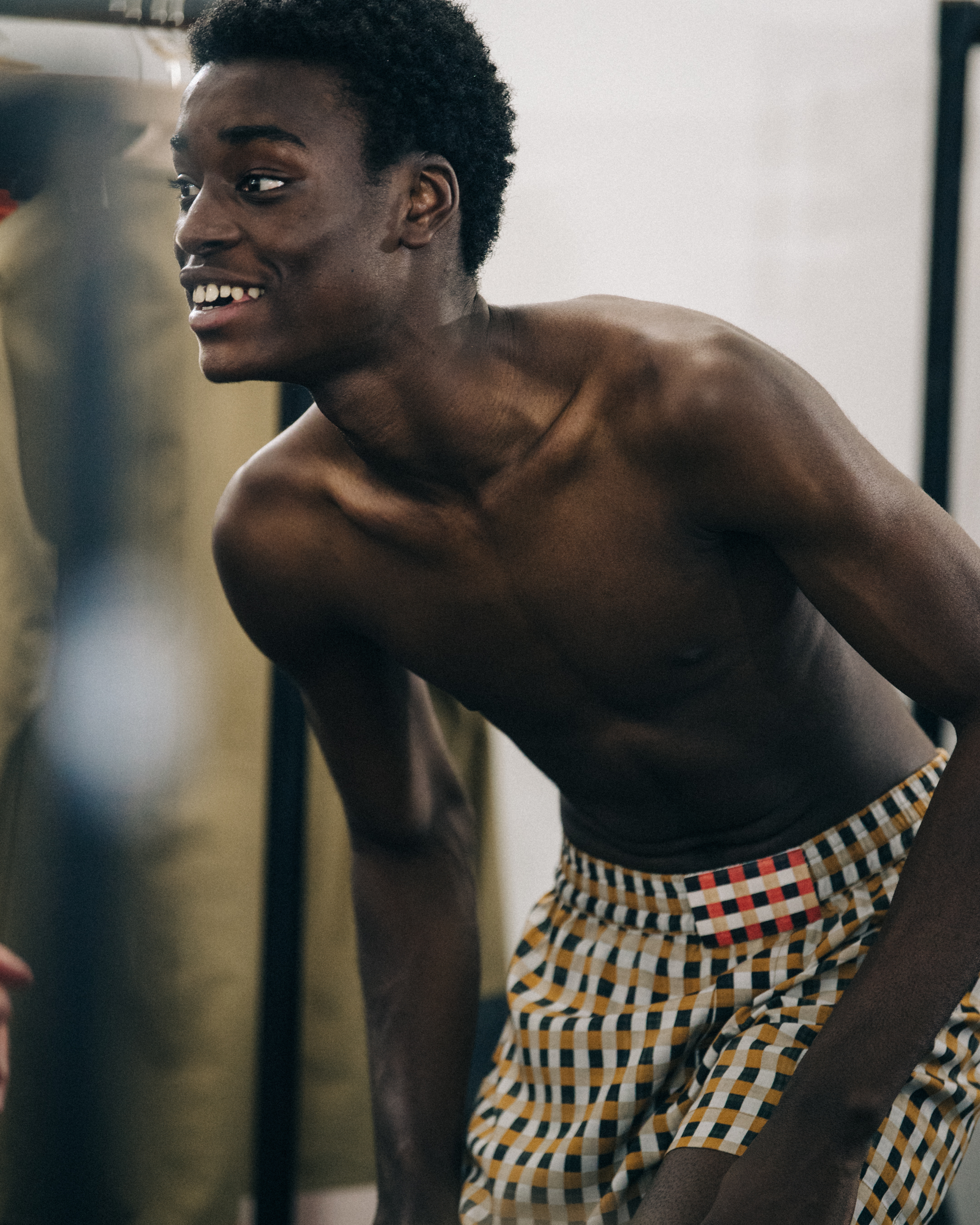 Model wearing check pattern at Qasimi