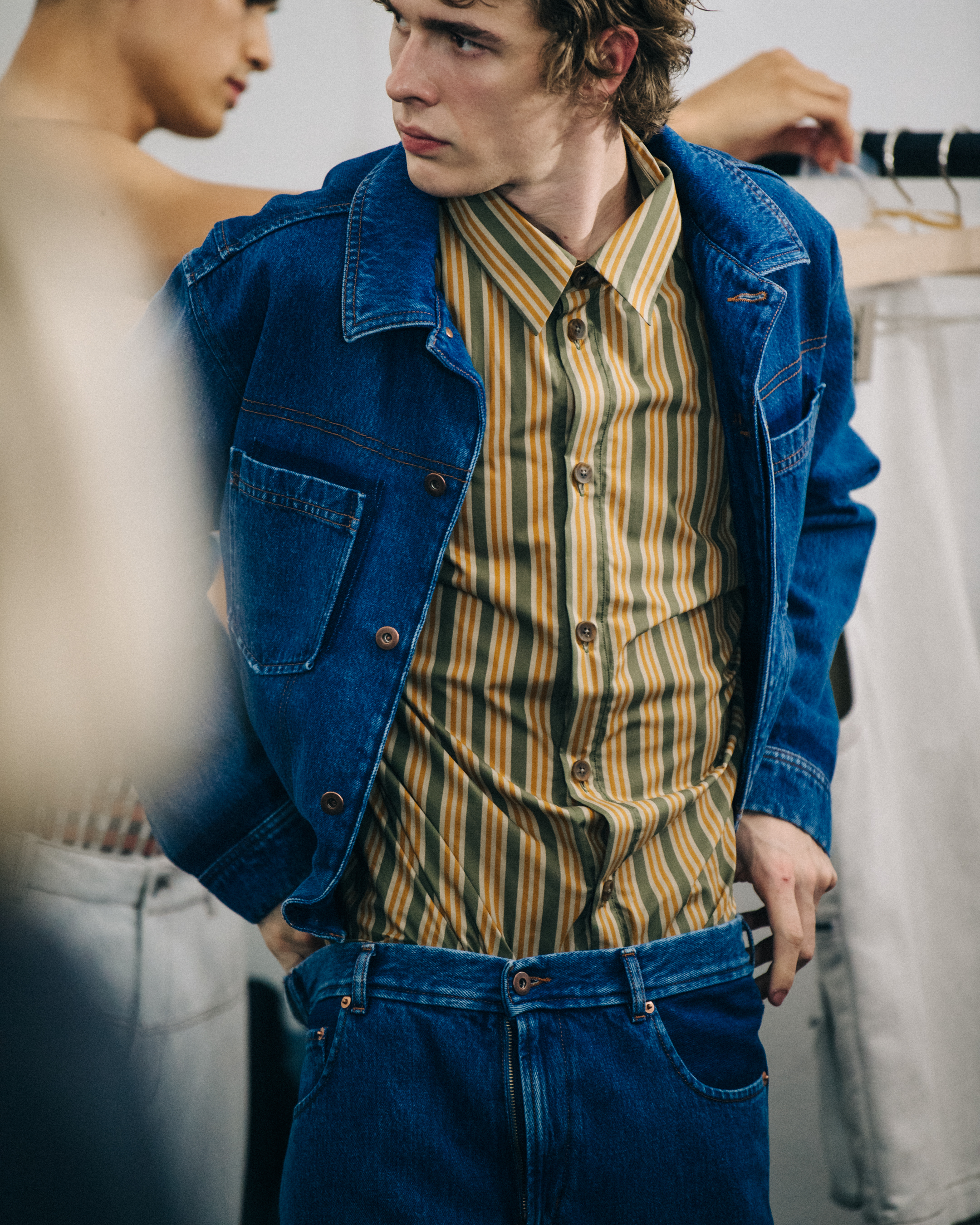 Model wearing blue jacket at Qasimi