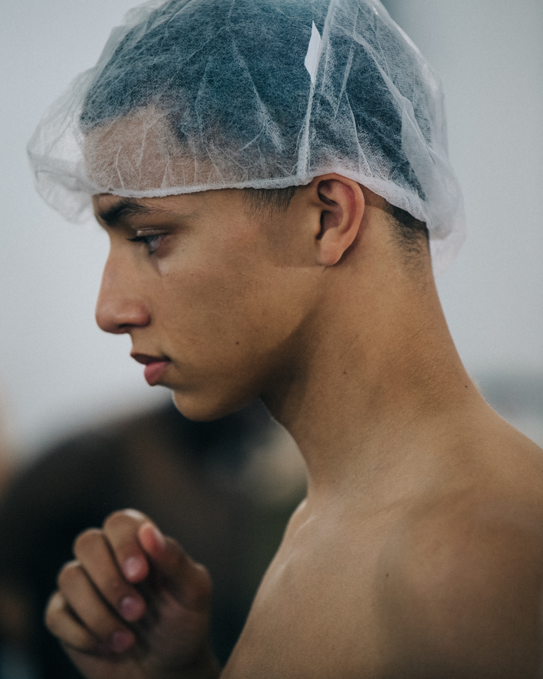Model wearing hair net backstage