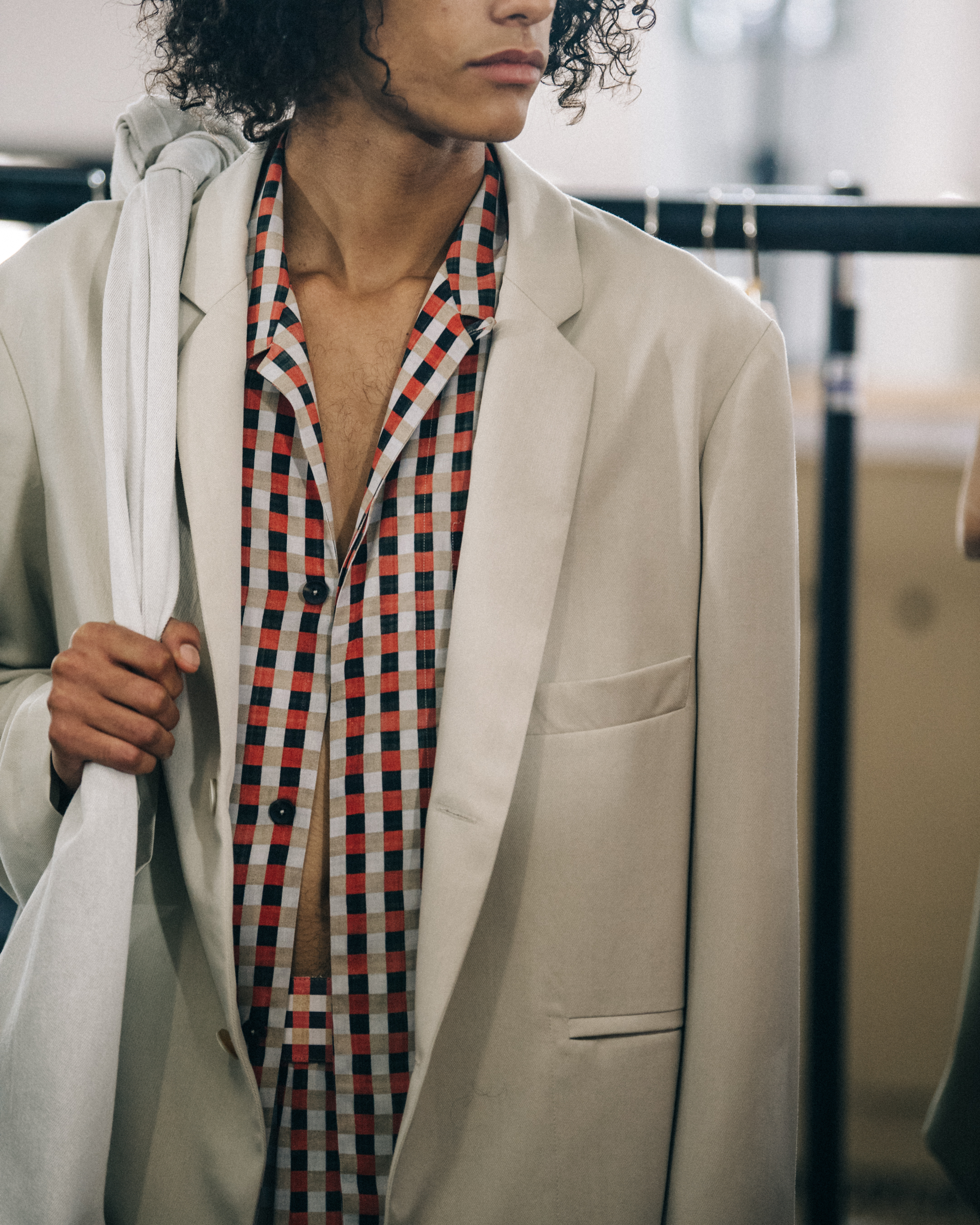 Model wearing check pattern at Qasimi