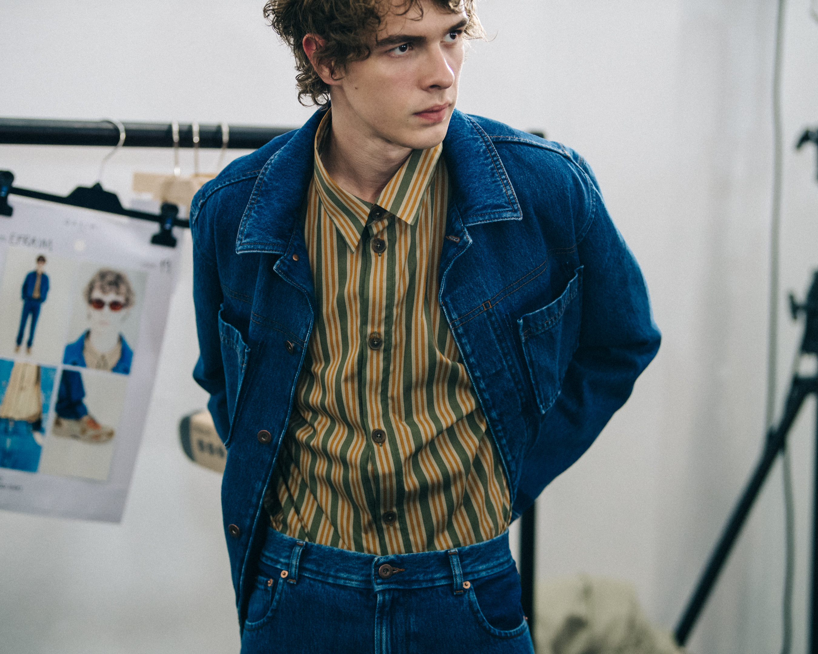 Model wearing blue jacket at Qasimi