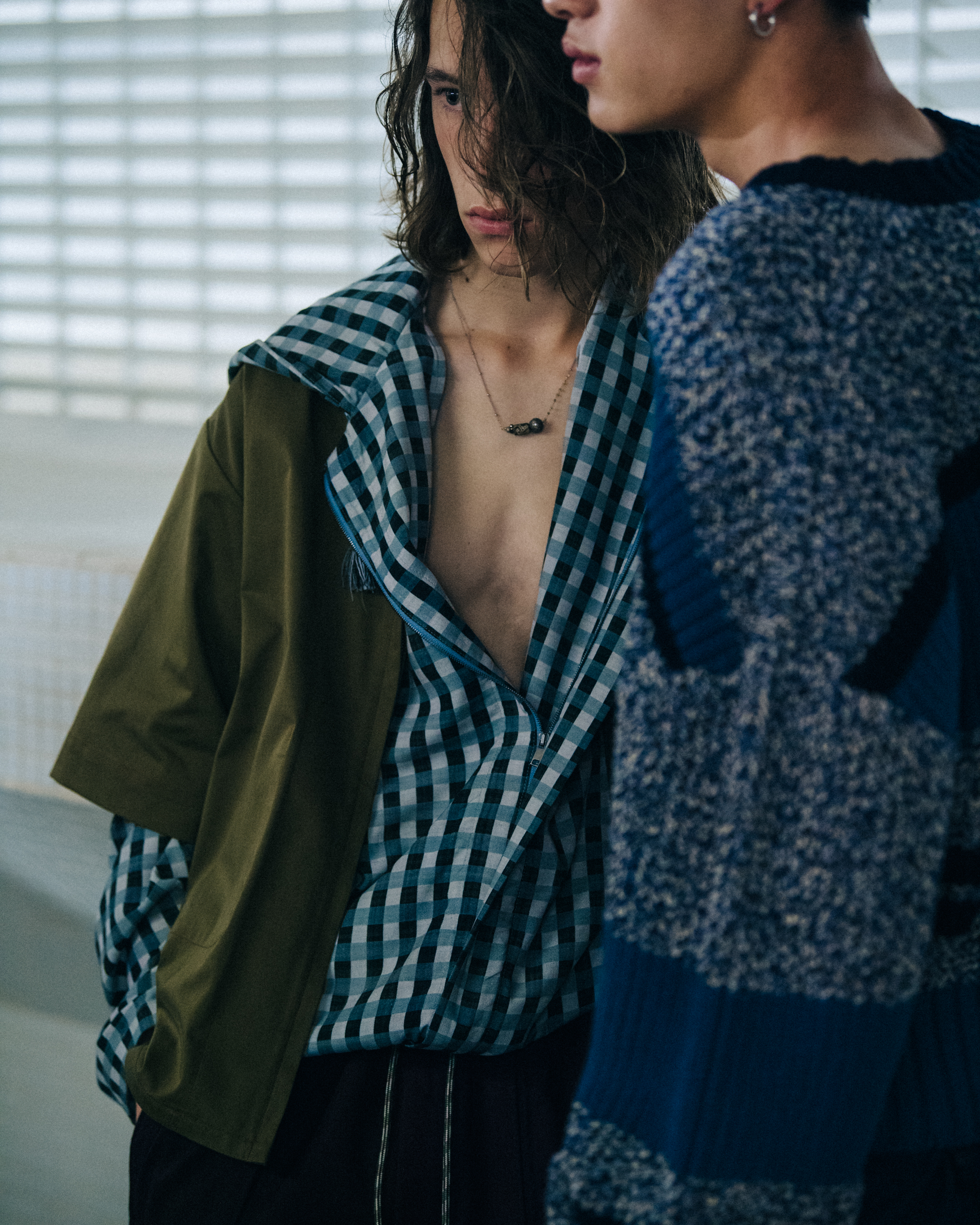 Model wearing check pattern at Qasimi
