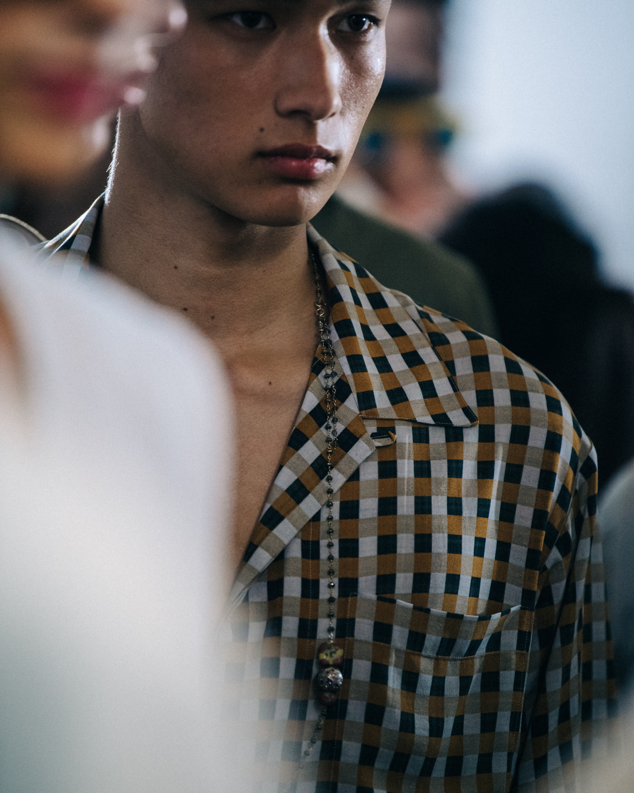 Model wearing check pattern at Qasimi