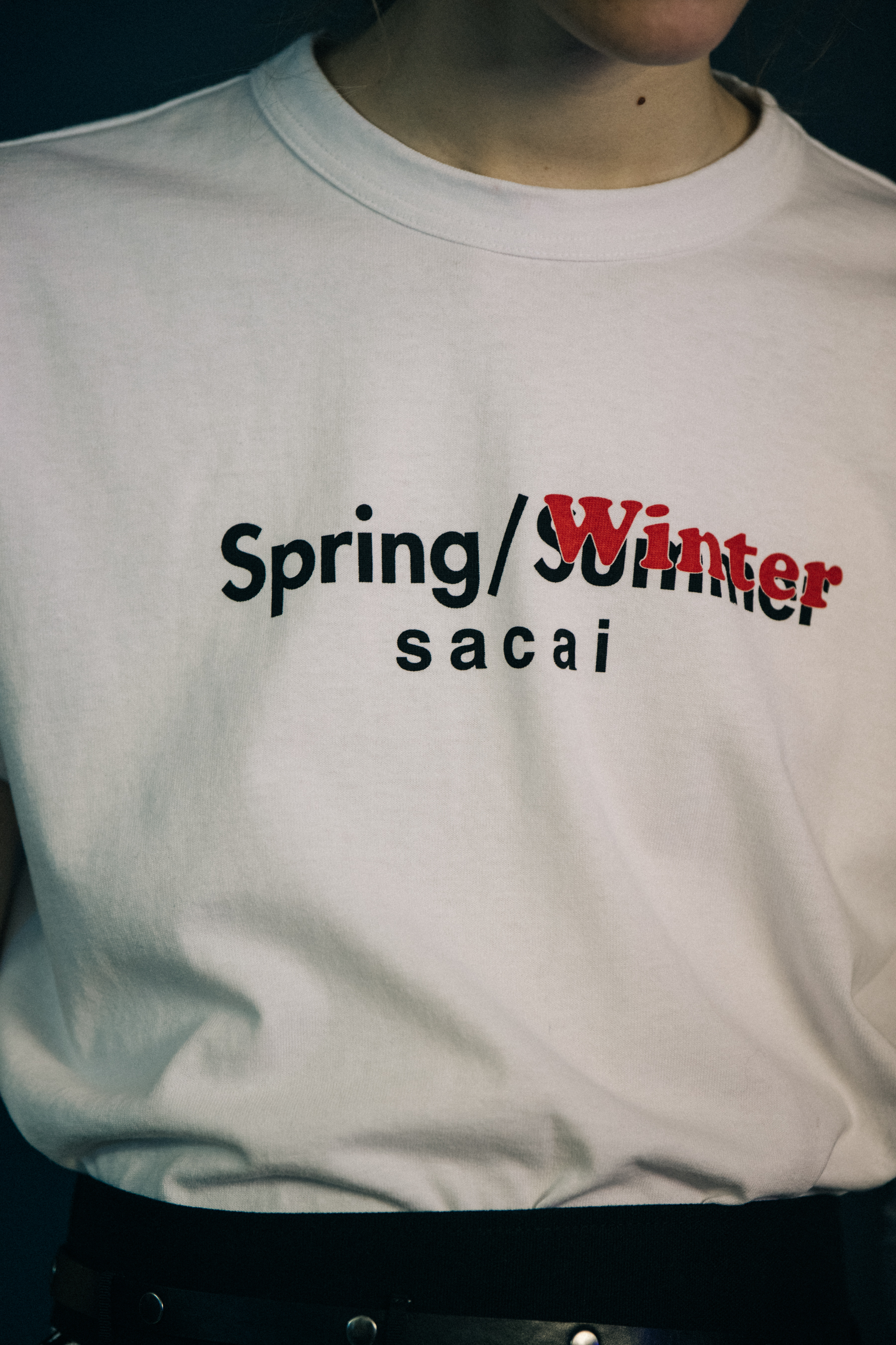 Model wearing white tee shirt at Sacai