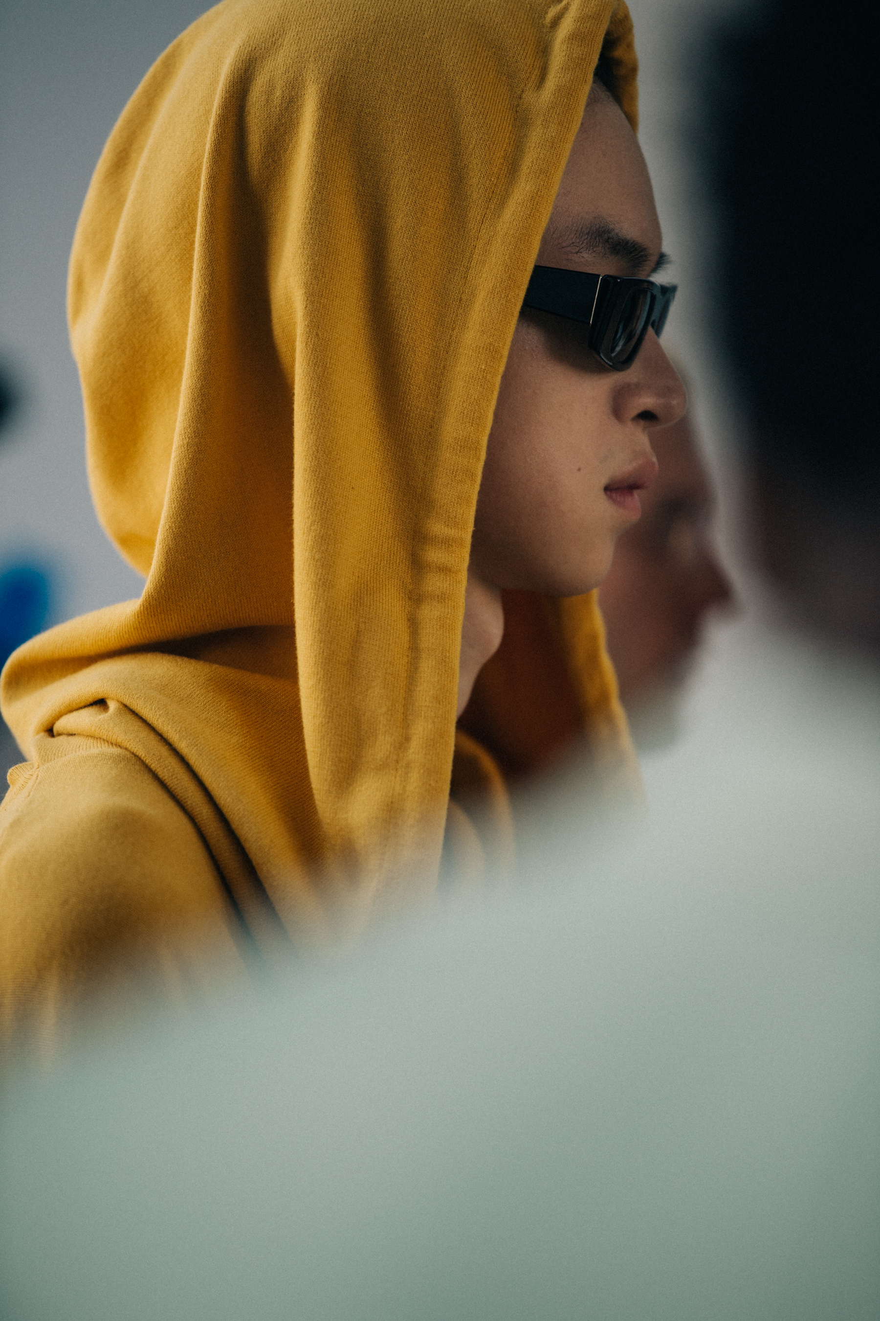 Model wearing sunglasses backstage at Sunnei