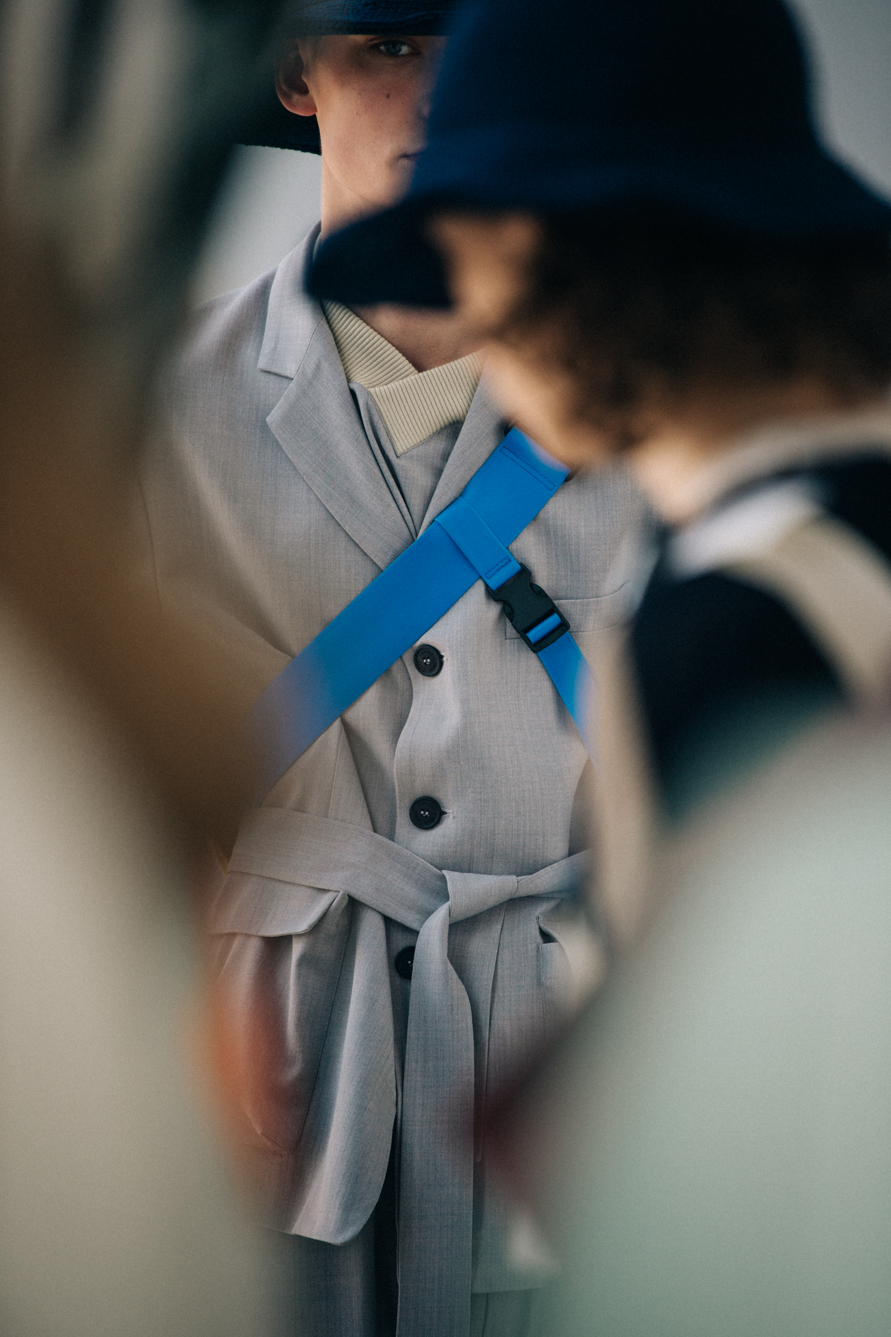 Model wearing hat backstage at Sunnei