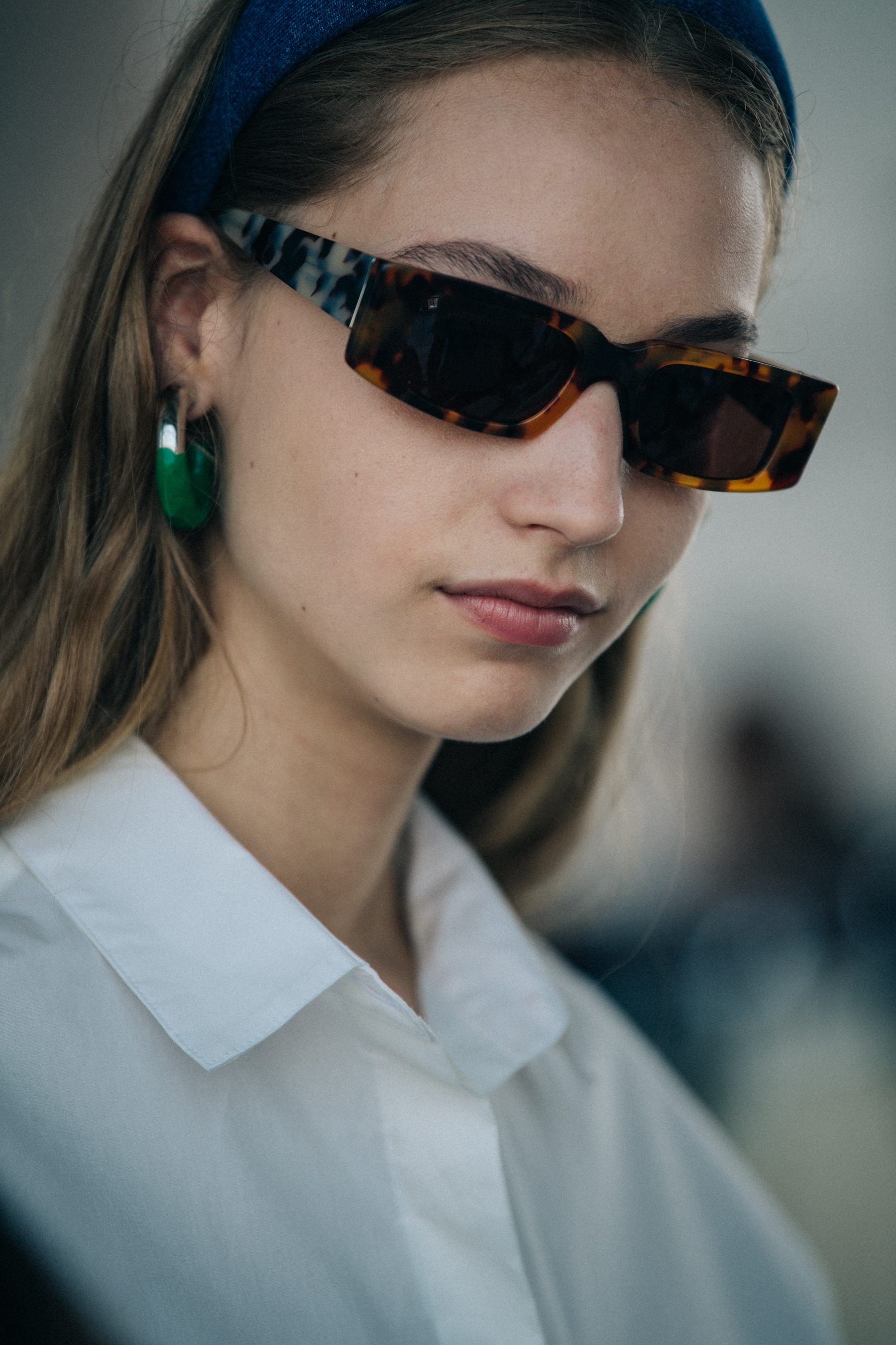 Model wearing sunglasses backstage at Sunnei