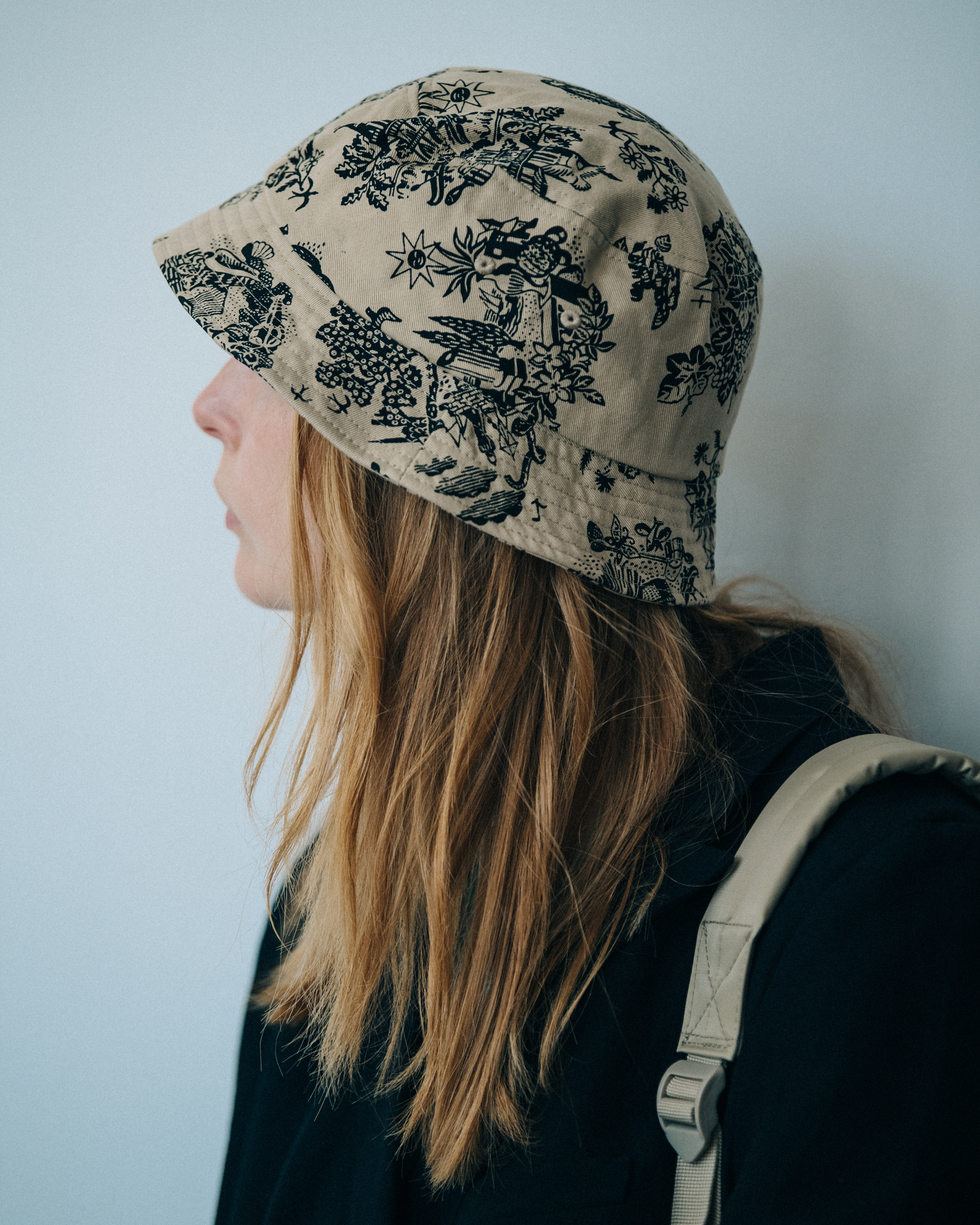 Model wearing tan hat at Wood Wood