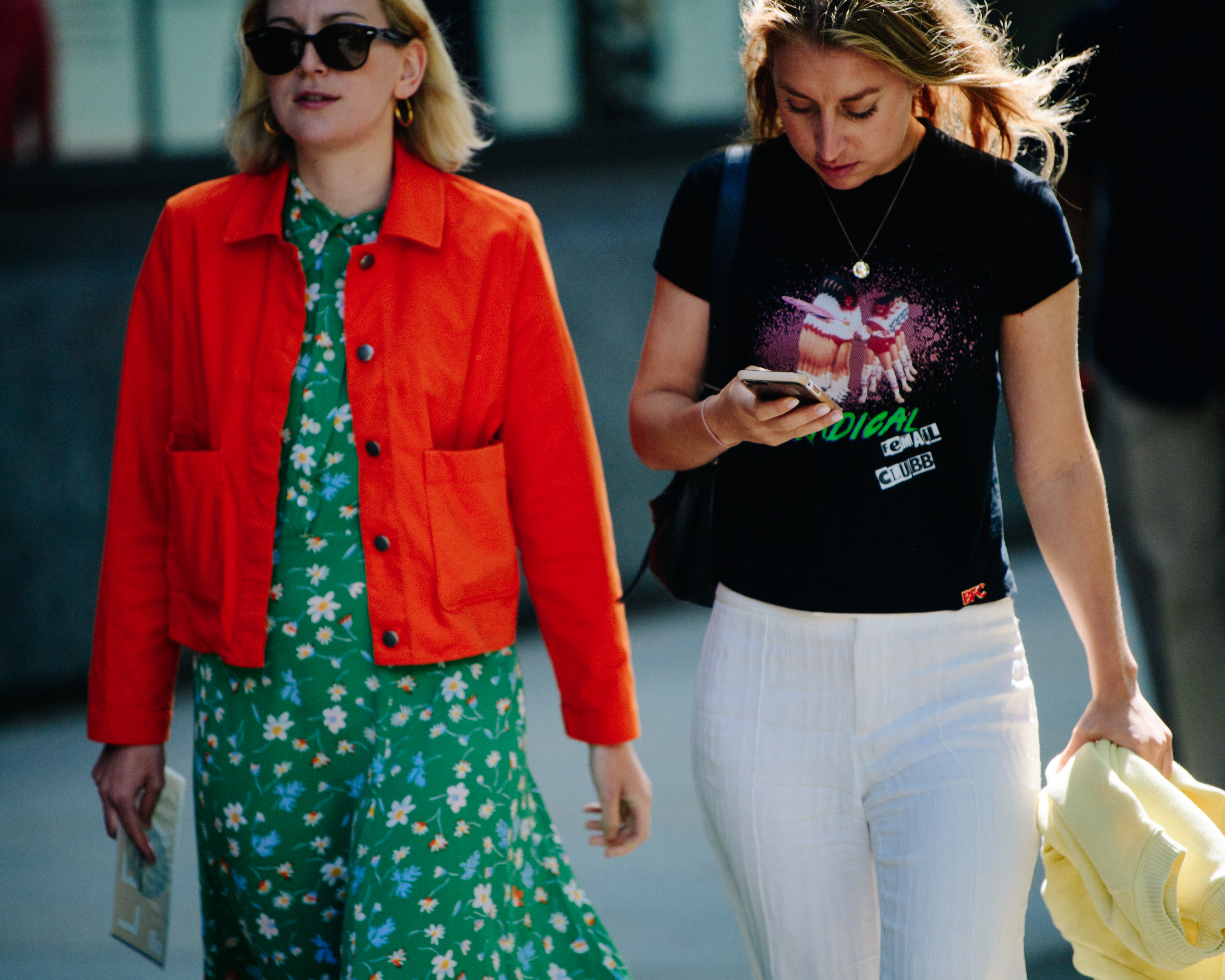 Two women wearing colourful clothing