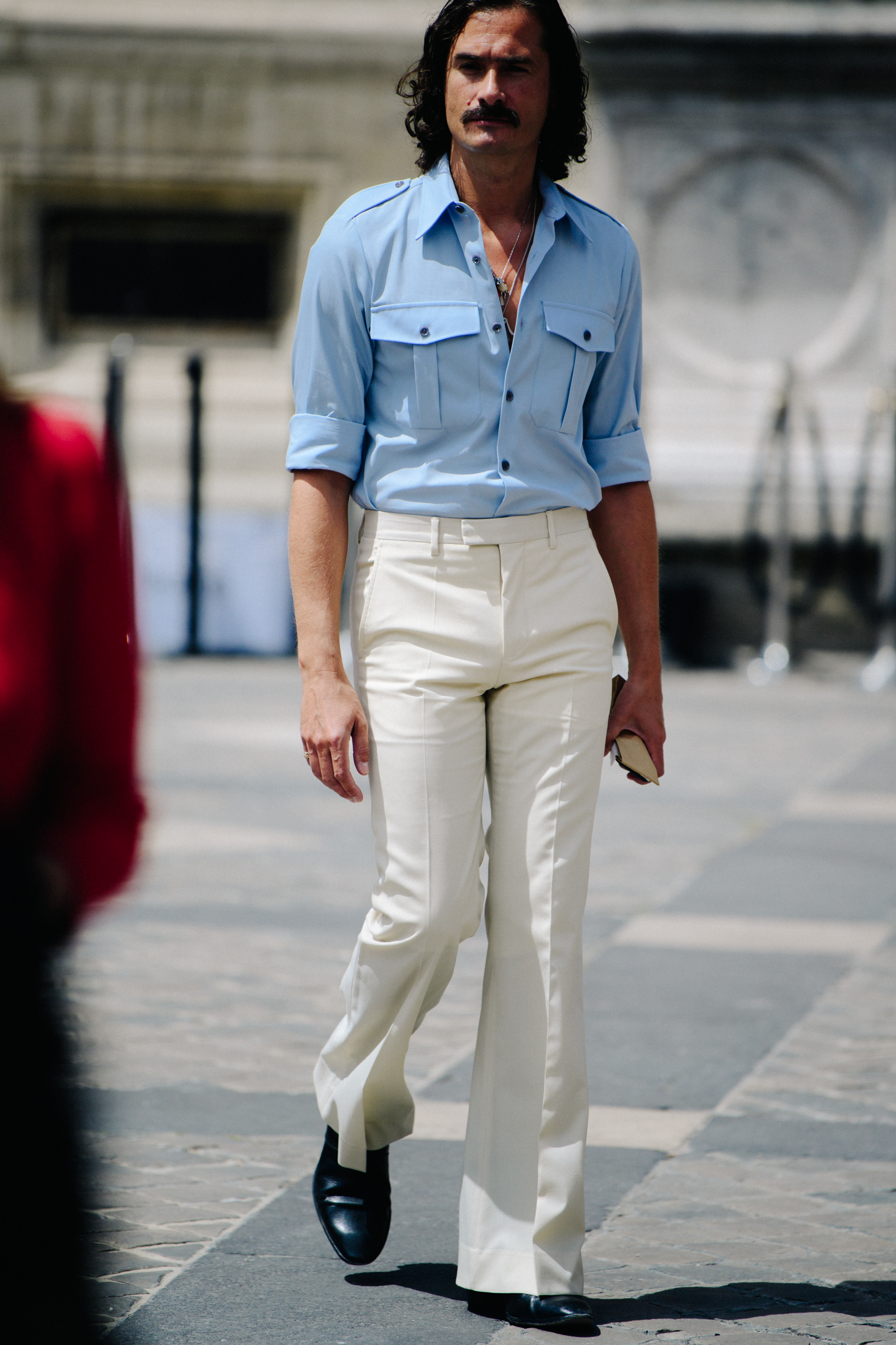 Man wearing blue shirt tucked in