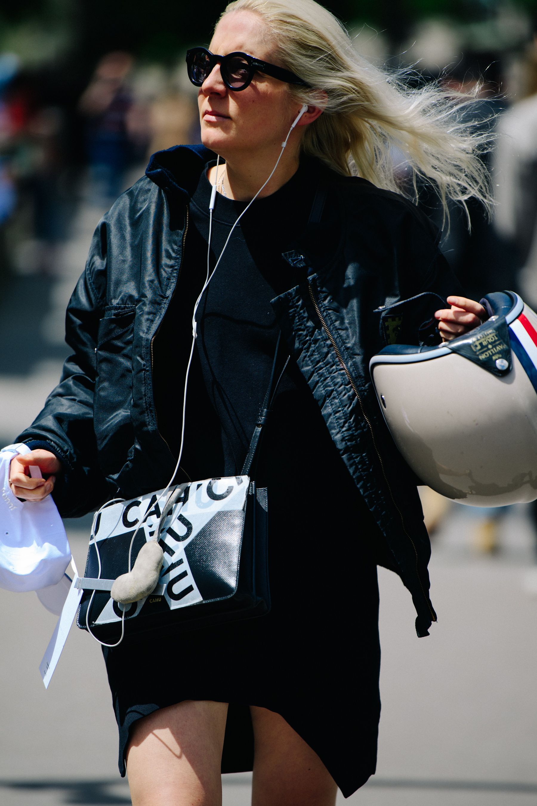 Woman carrying motorcycle helmet
