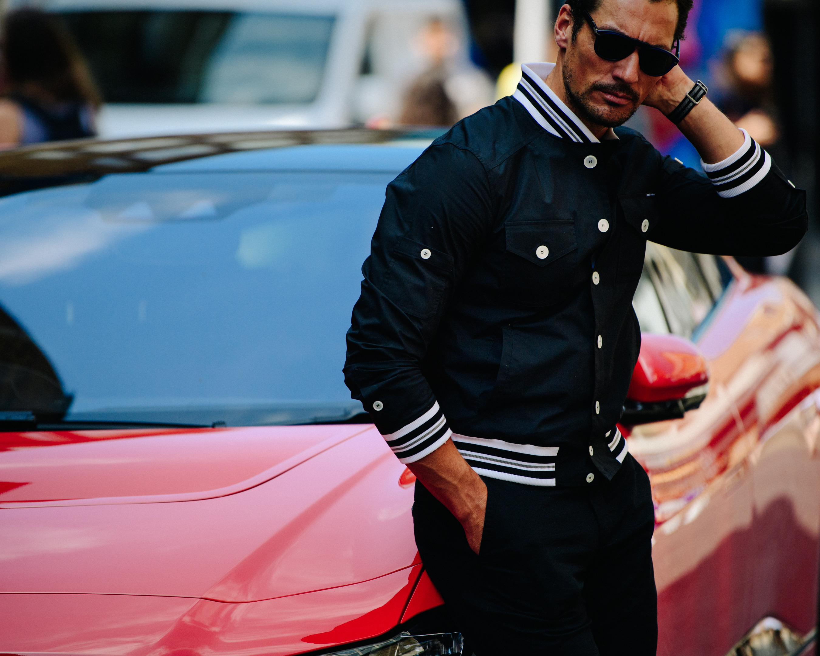 David Gandy leaning against red car