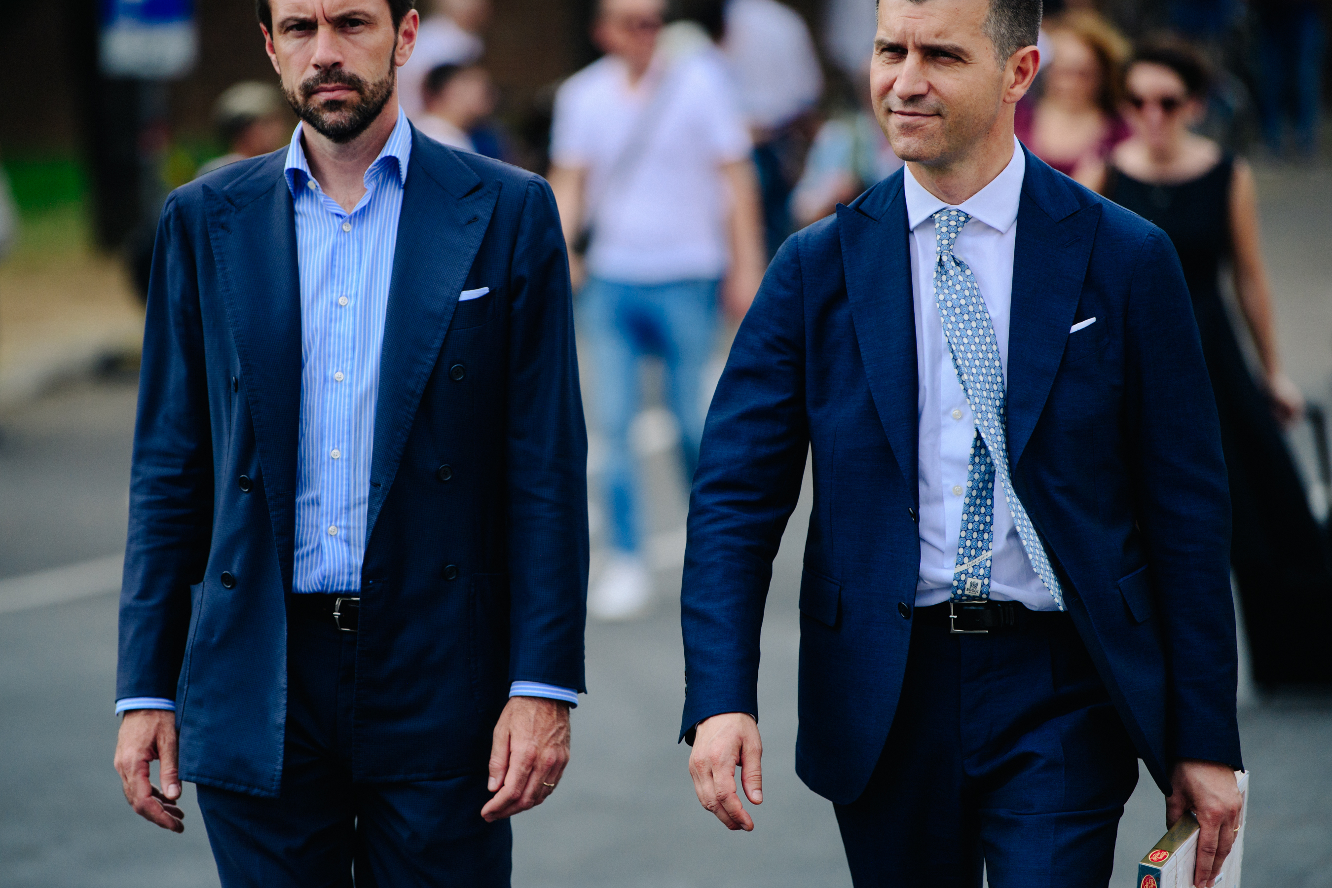 Two men wearing blue suits
